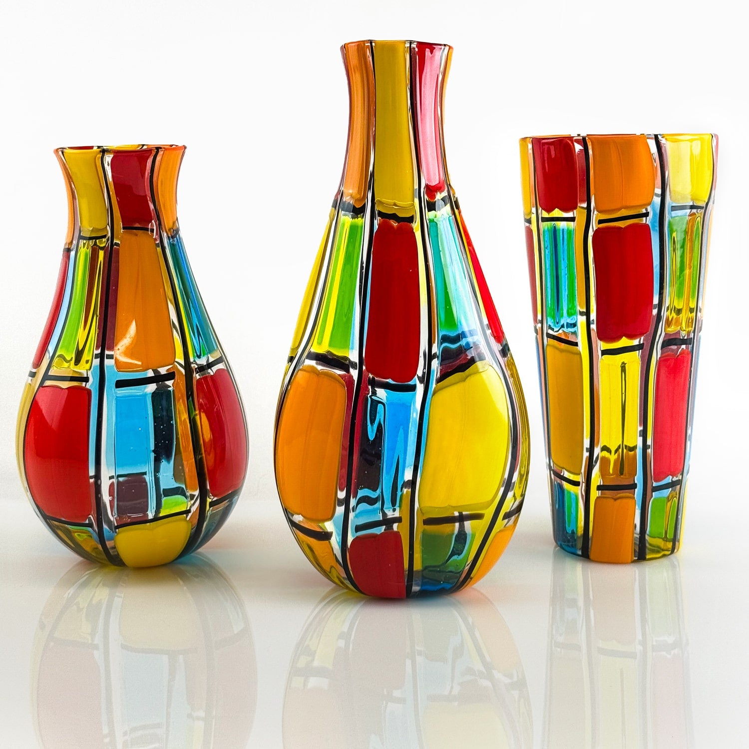 Large Murano glass cylinder vase by Pazzia, signed by the artist, with vibrant colors and smooth, transparent glass finish.
