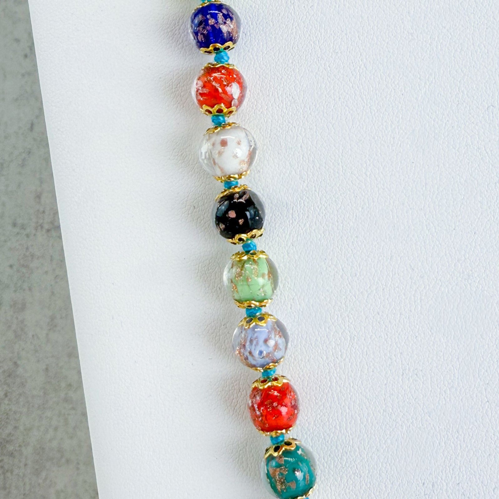 Beaded multicolor Avventurina knotted Murano glass necklace with intricate glass beads and vibrant design.