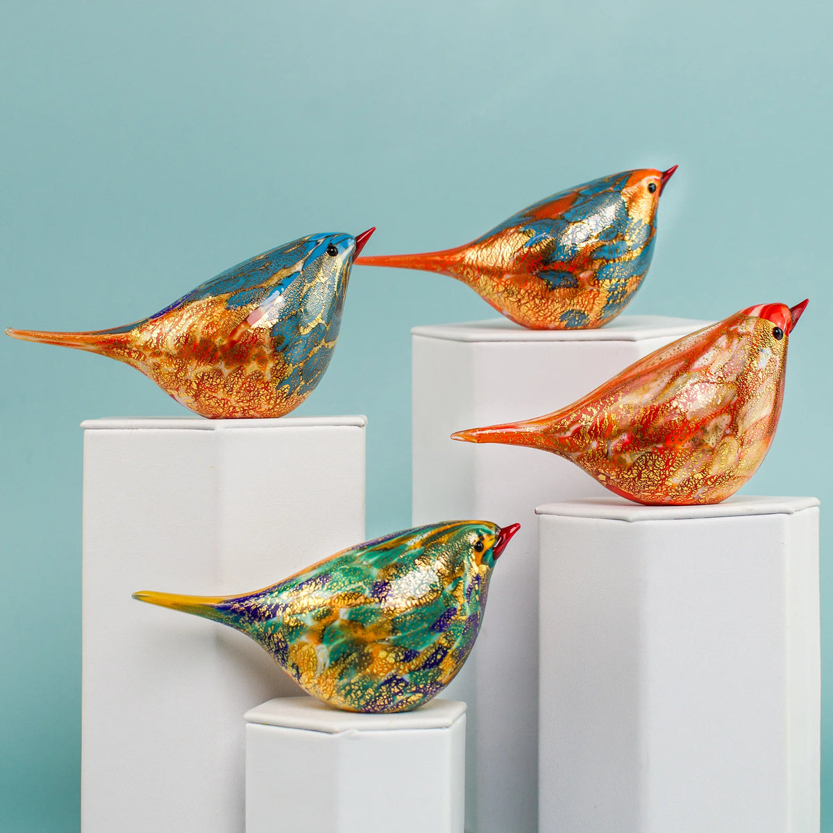 Handblown Murano glass Chirpie bird figurine in orange and teal by Rocco, showcasing vibrant colors and intricate craftsmanship.