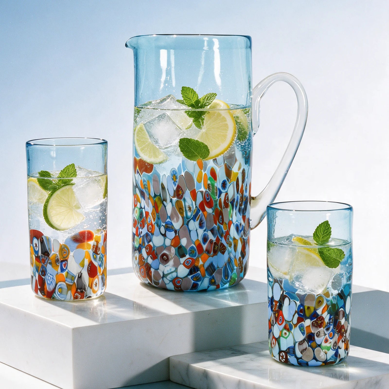 Set of Murano glass drink tumblers and pitcher from DZ's San Marco Collection, featuring colorful, hand-blown Italian glassware.