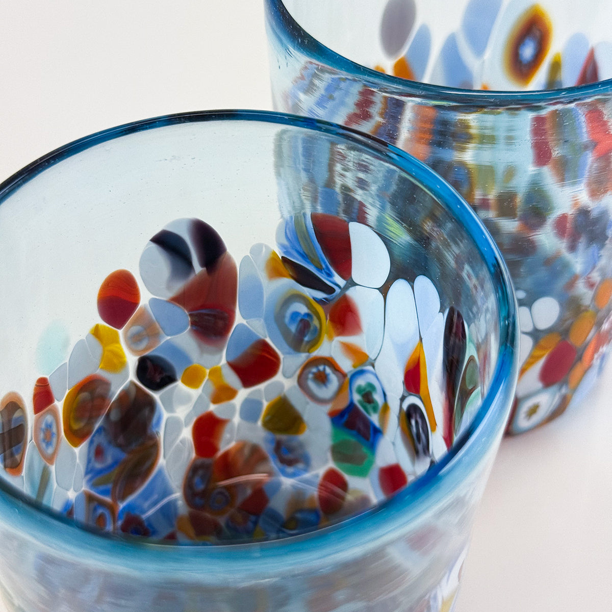 Colorful glass bowls with a mosaic pattern on a light background