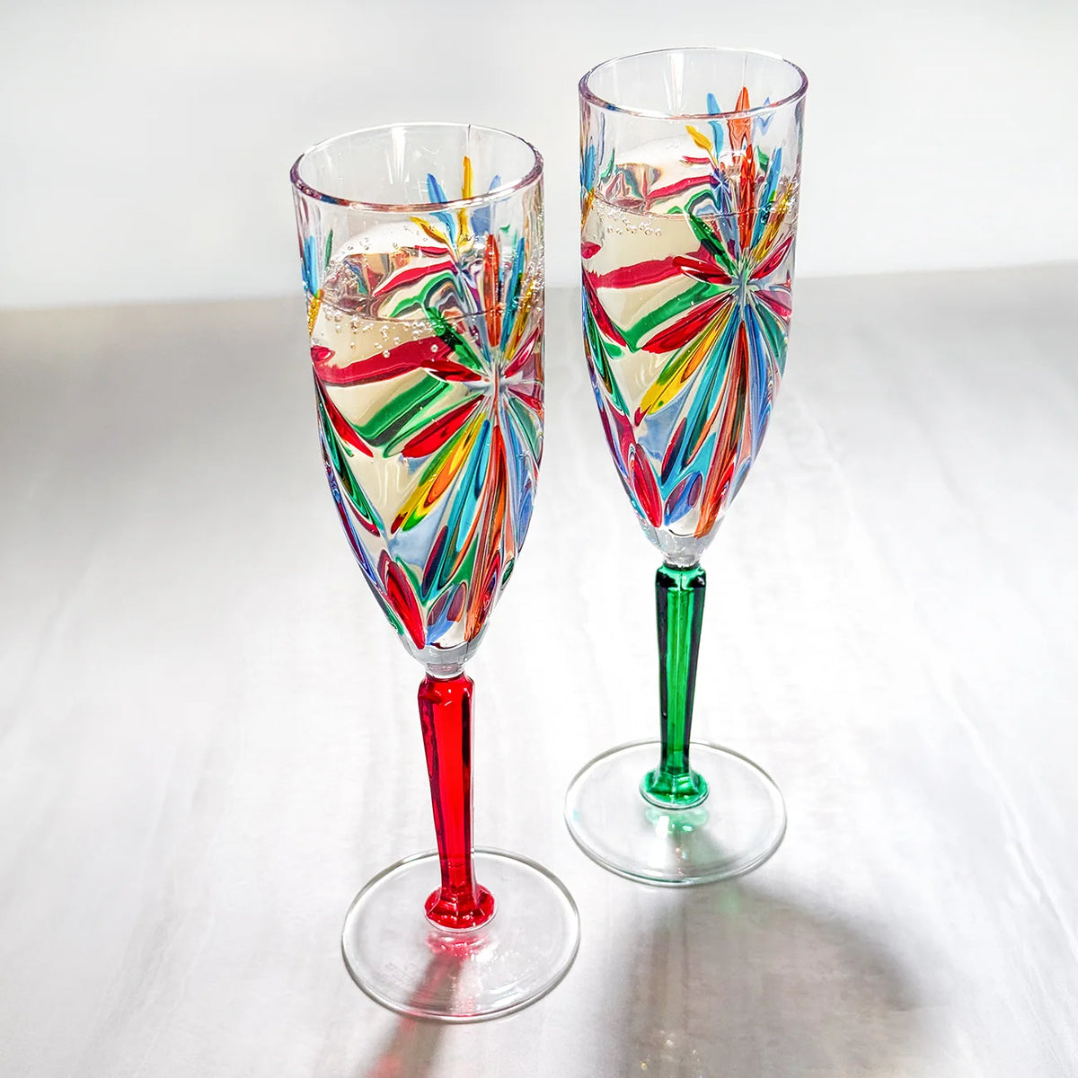 Set of two DZ Starburst Champagne flutes with a modern multi-color starburst design, made in Italy, for elegant celebrations.