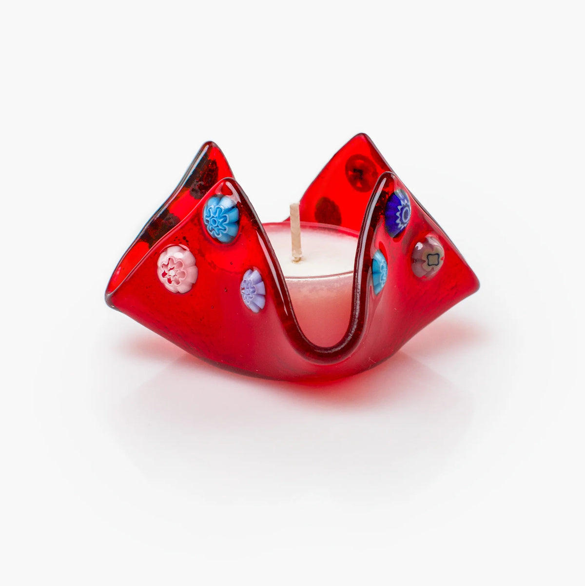 Colorful Murano glass Millefiori candle votive holder with intricate patterns, made in Italy, displayed on a decorative tray.