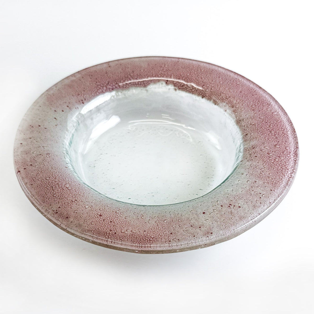 Glass bowl with a speckled pink rim on a white background