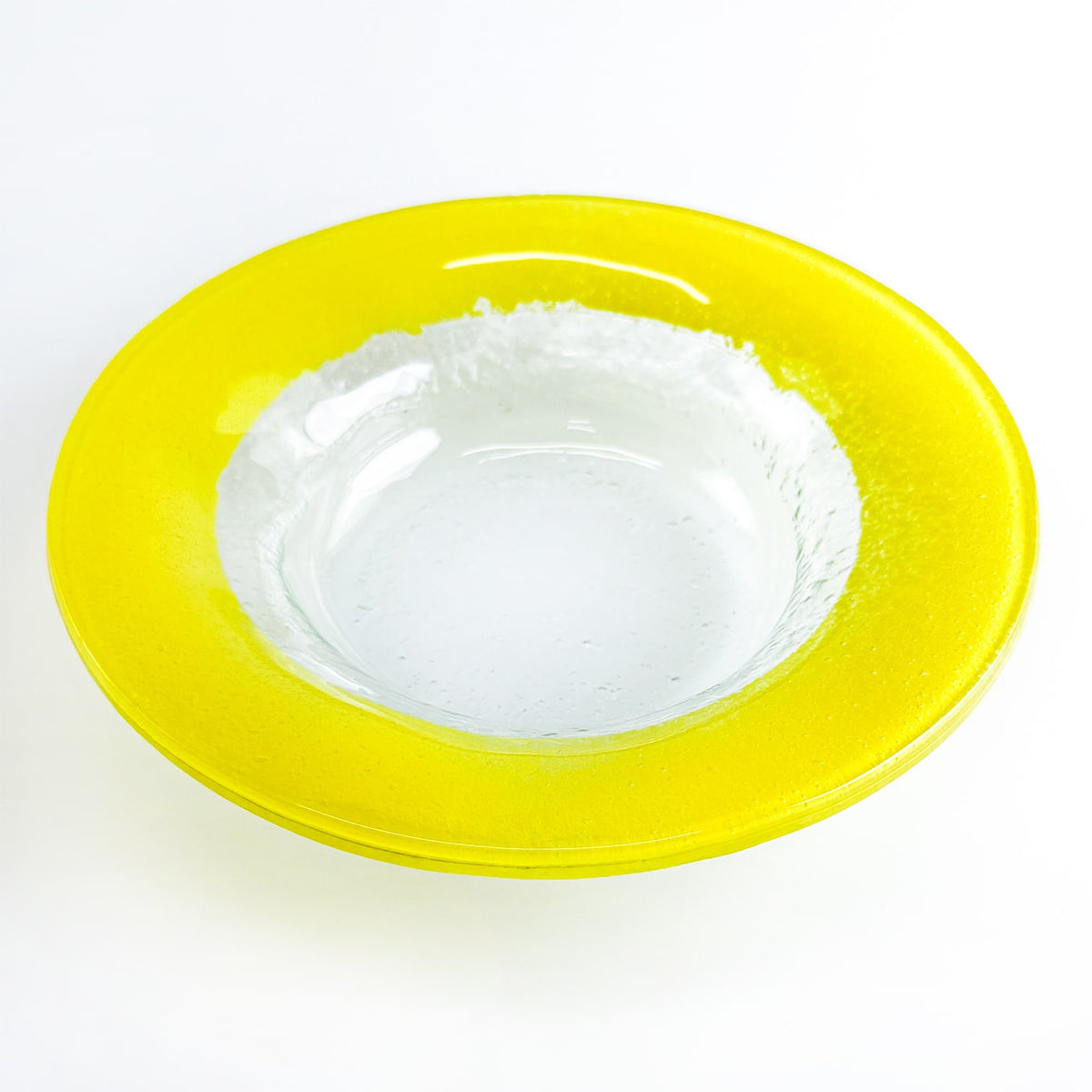 Yellow rim glass plate on a white background