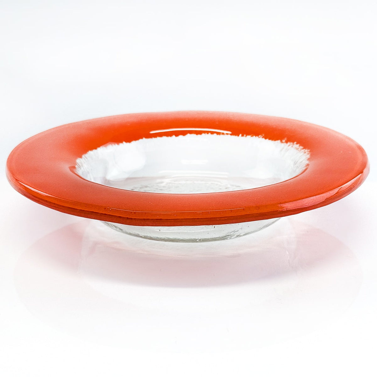 Glass bowl with an orange rim on a white background