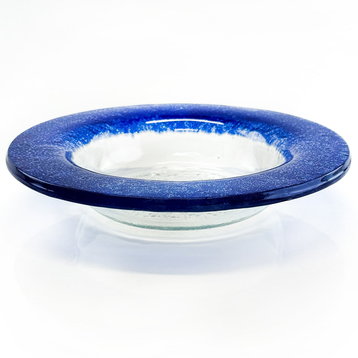 Clear glass bowl with blue speckled rim on a white background