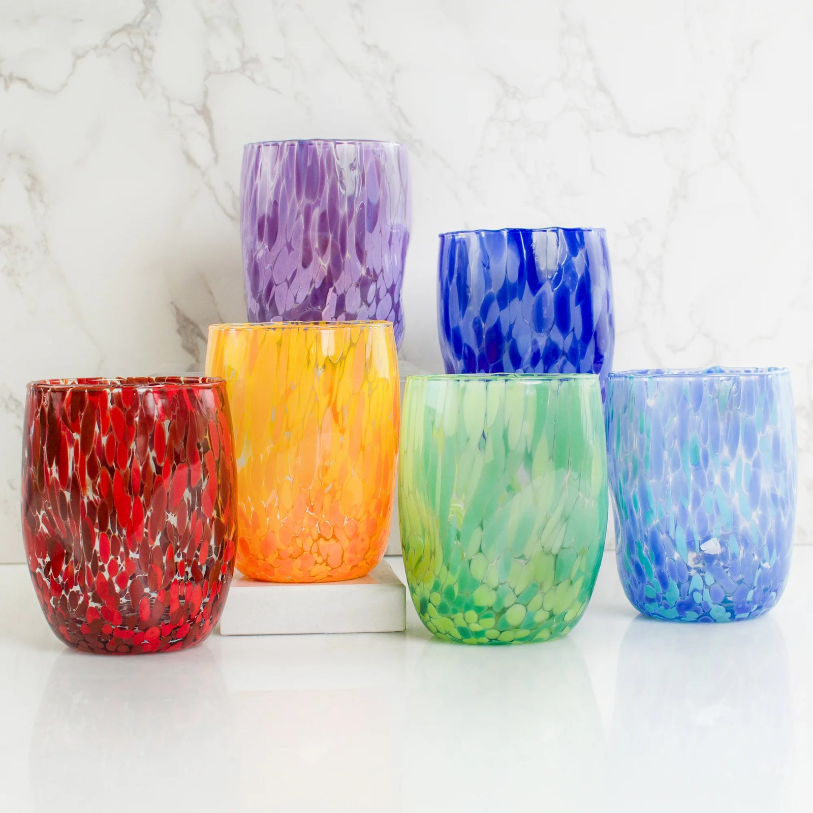 Set of DZ Viva Murano glass tumblers with vibrant, colorful patterns, made in Italy, showcasing handcrafted Italian glassware.