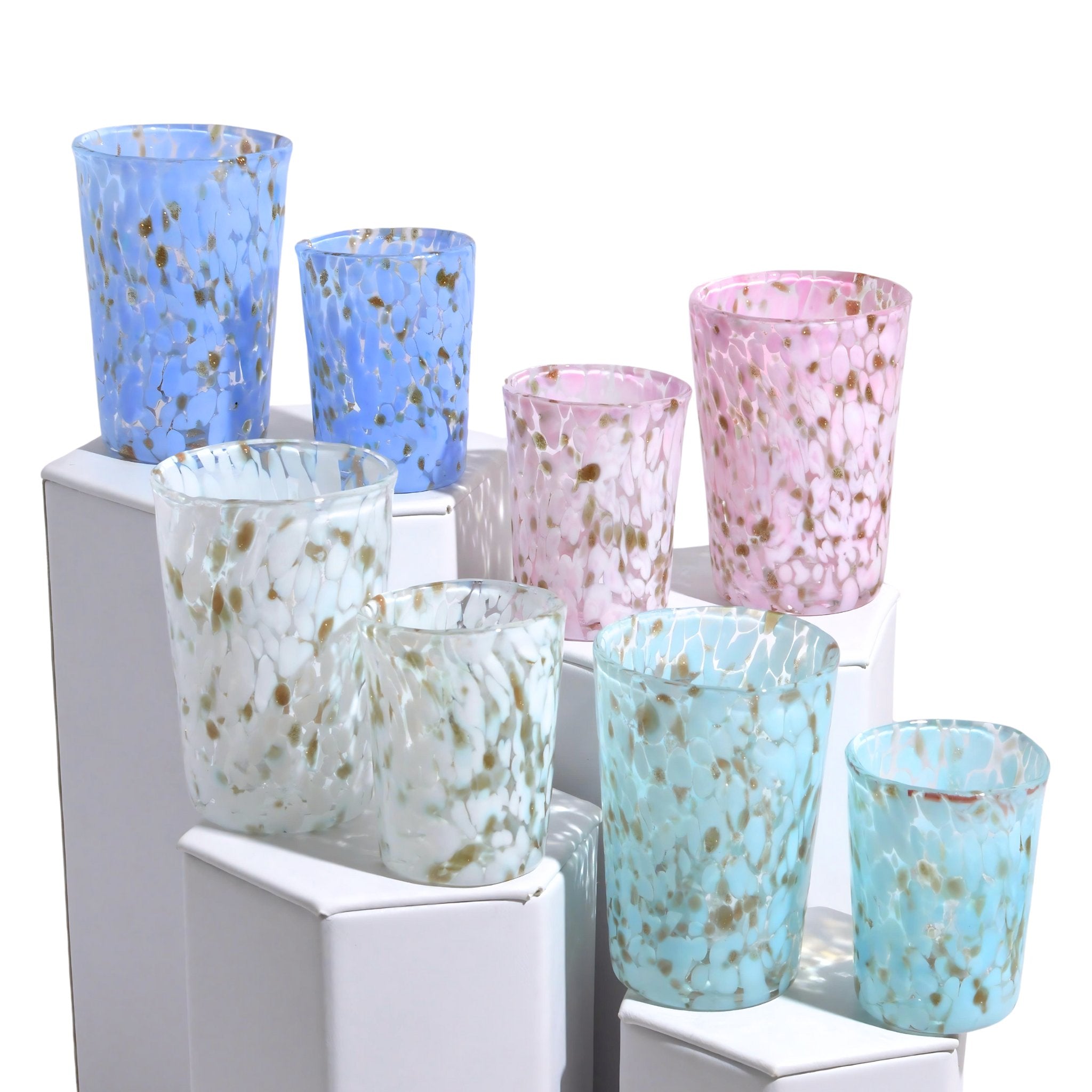 Stacked Murano Glass Tesoro shot glasses from Italy with colorful, intricate designs, showcasing artisanal craftsmanship and vibrant patterns.