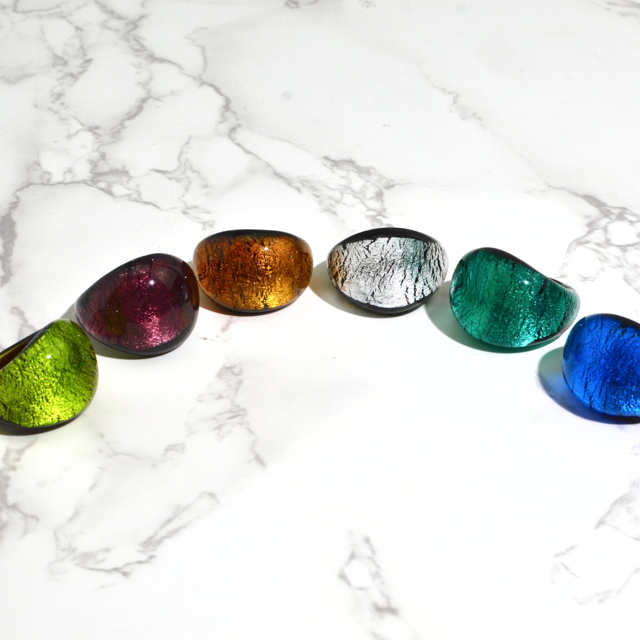 Set of Murano Glass Arno Statement Rings in cobalt, teal, and silver, featuring vibrant colors and intricate designs from Italy.