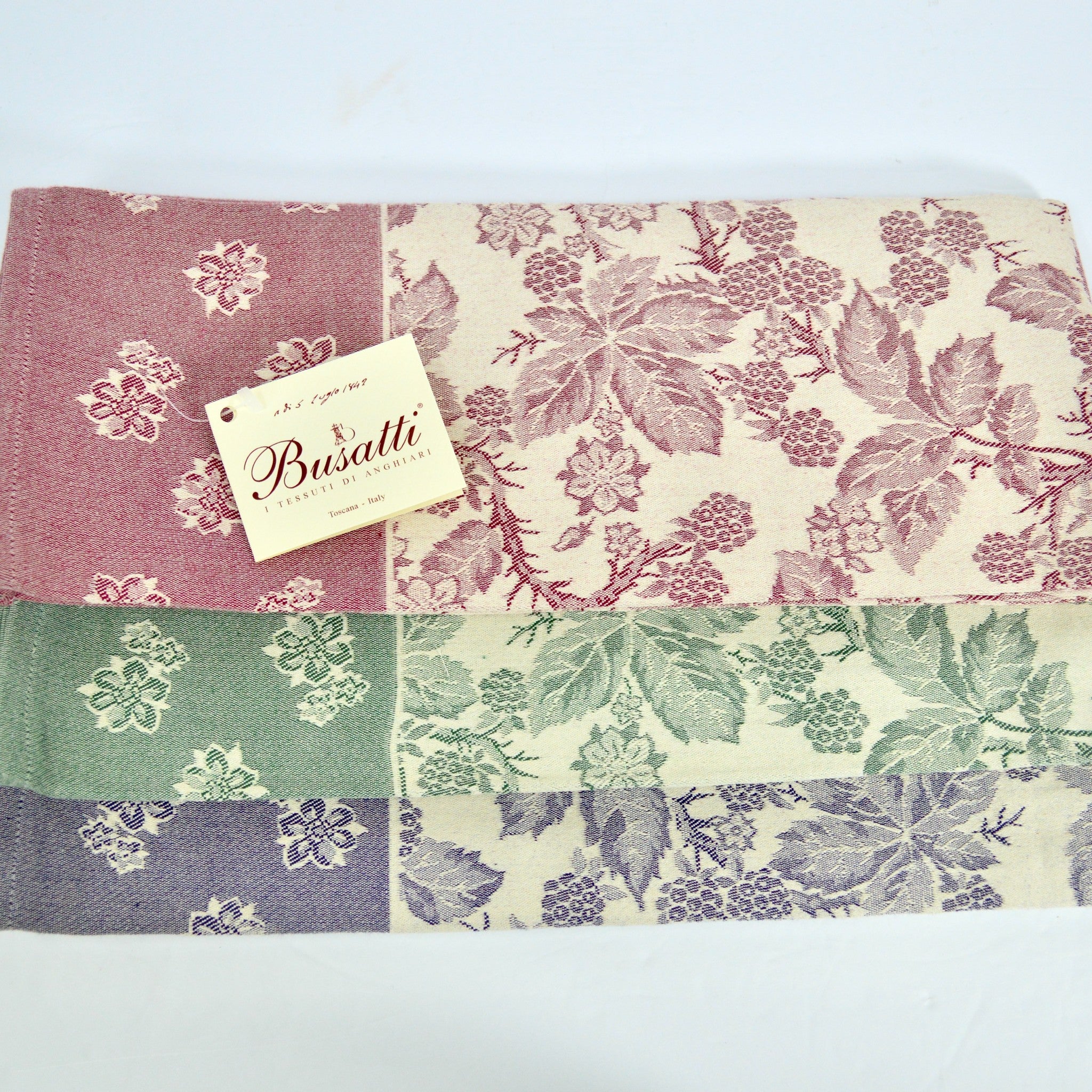 Assorted colorful Busatti Berry kitchen towels made of Italian linen, showcasing vibrant patterns and craftsmanship.