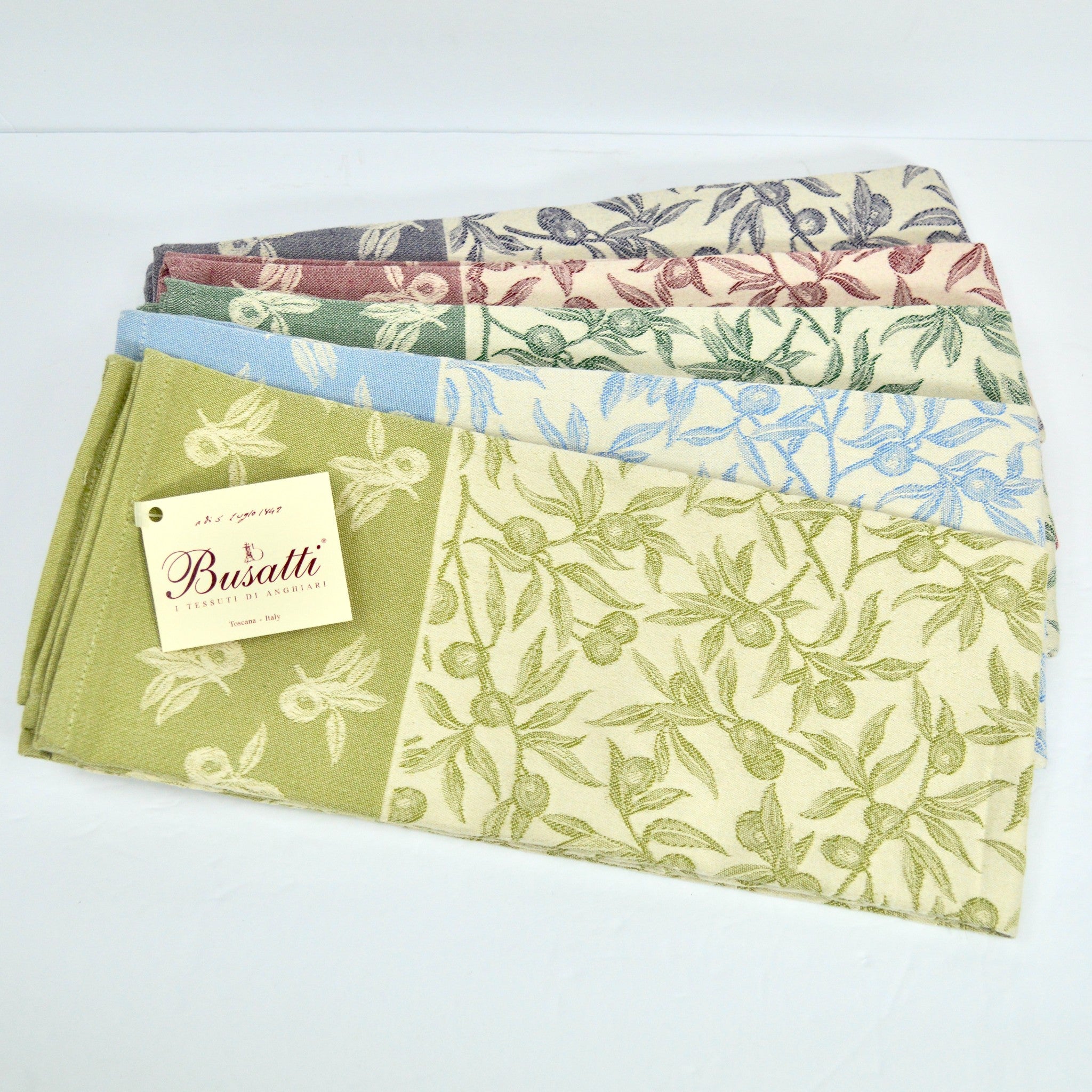 Assorted colorful Busatti Oliva kitchen towels made in Italy, showcasing vibrant table linens from the My Italian Decor collection.