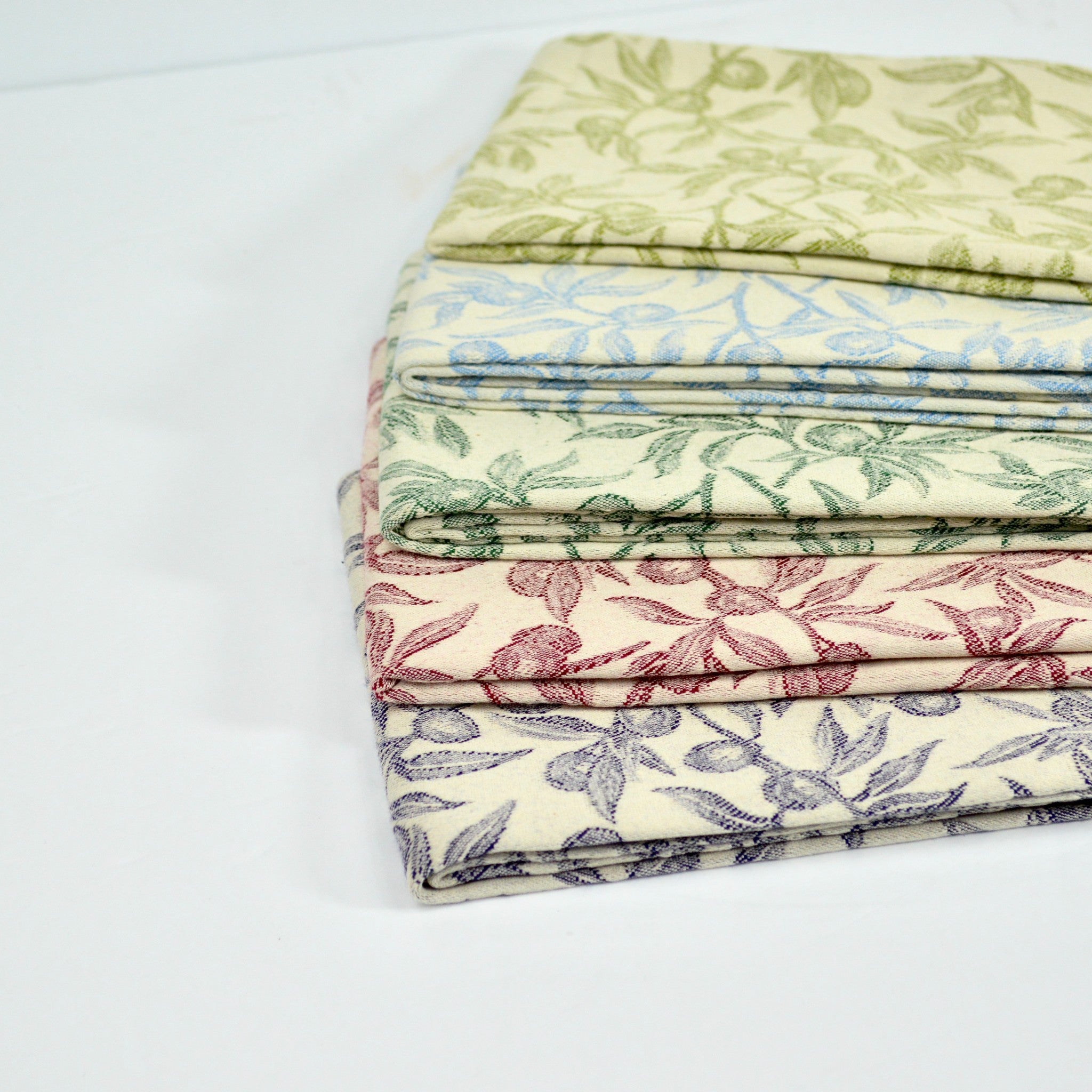 Colorful Busatti Oliva kitchen towels displayed in assorted shades, made in Italy, ideal for kitchen and table linen use.