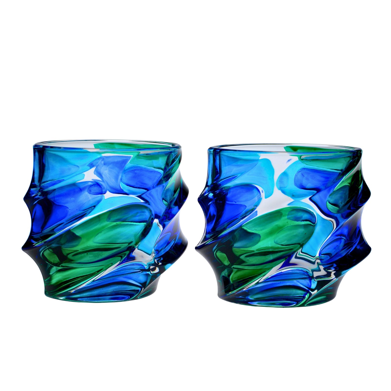 Set of two DZ Caly short drink glasses in blue and green hand-painted crystal tumblers on matte background.