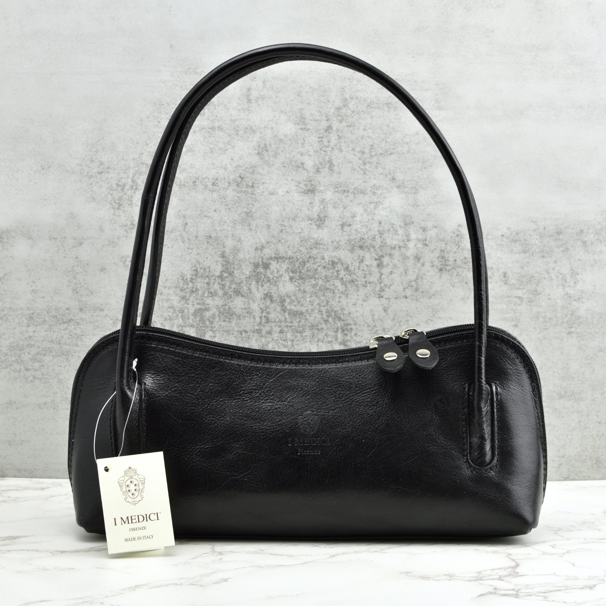 Black Carina shoulder bag made of Italian leather, stylish handbag with sleek design and top handle for versatile carry.