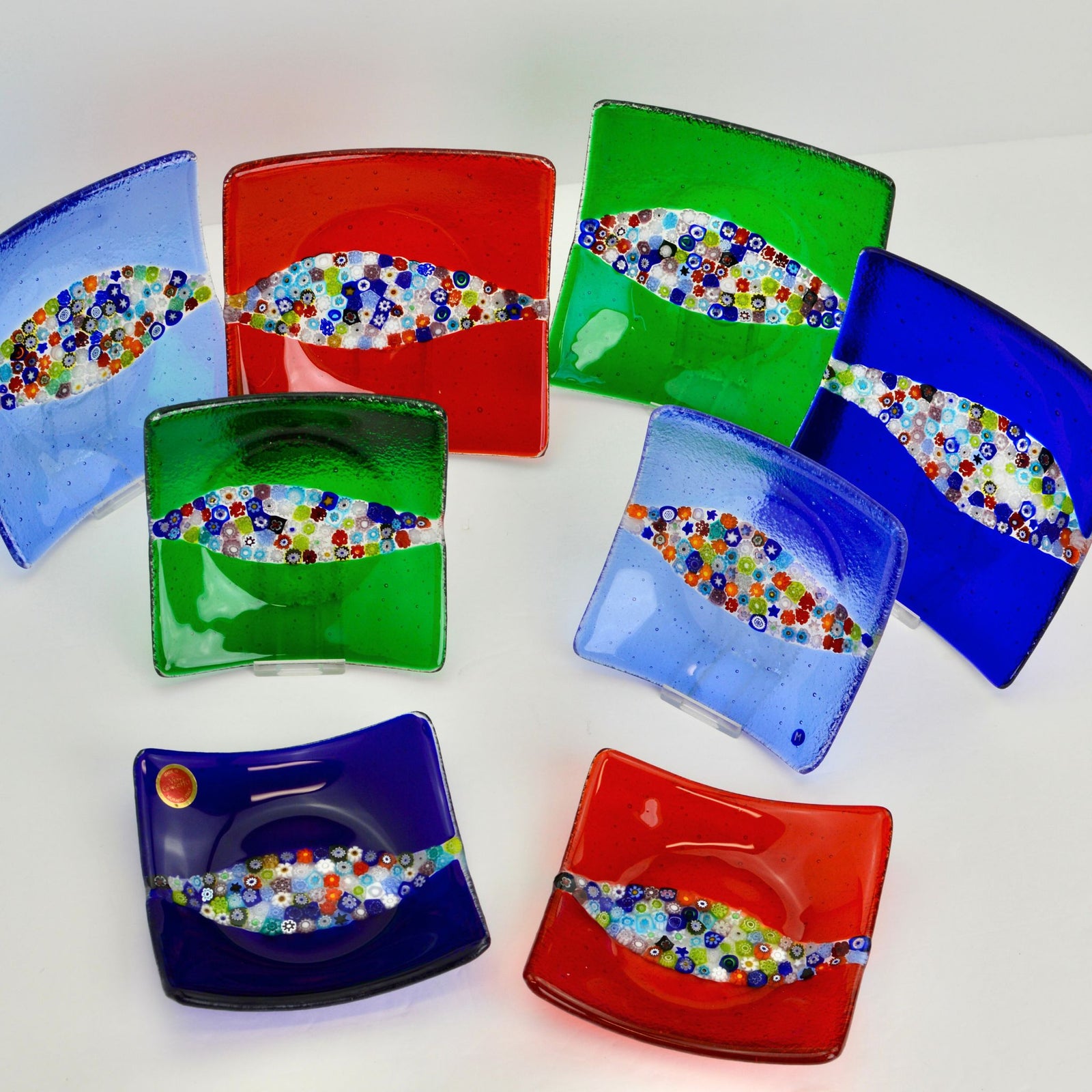 Close-up of a red Murano Glass Millefiori Collina Dish, a 6-inch decorative tray with colorful floral patterns.
