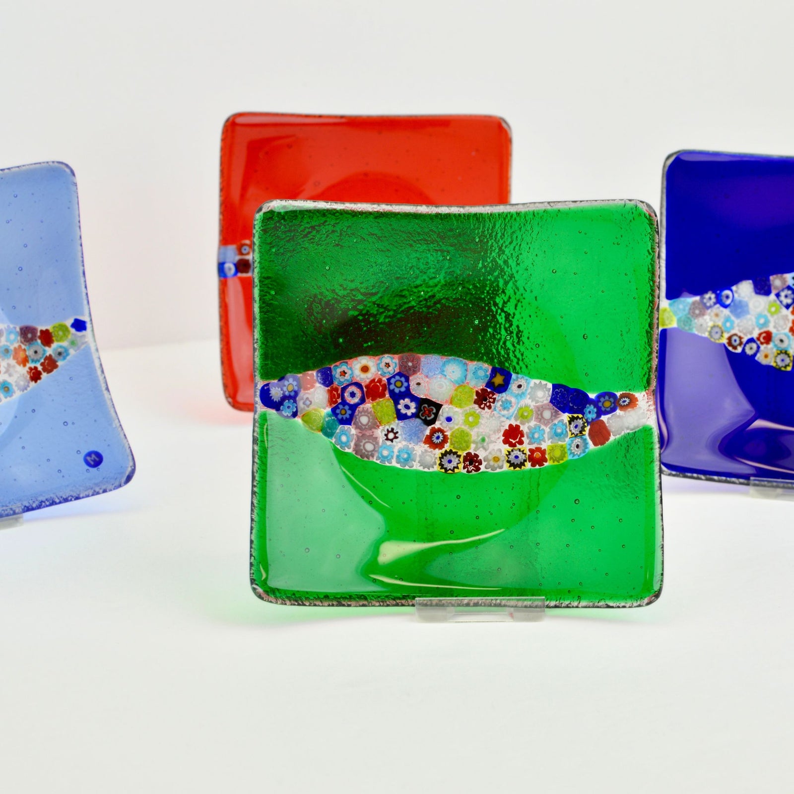 Close-up of red Murano Glass Millefiori Collina Dish, a 6-inch decorative tray with colorful floral glass patterns.