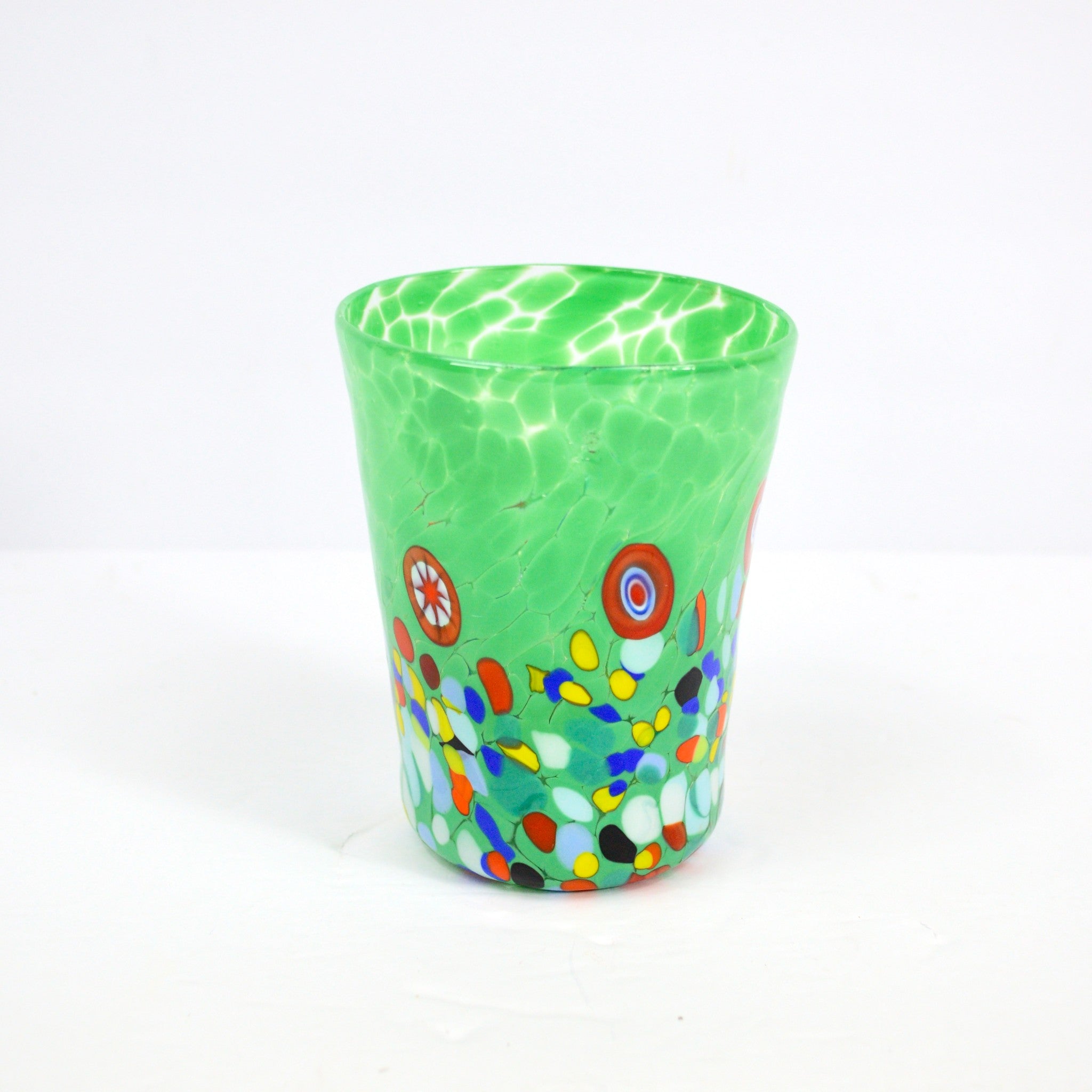 Dark green Medici Murano Glass tumbler with colorful millefiori patterns, handcrafted for elegant drinking experience.