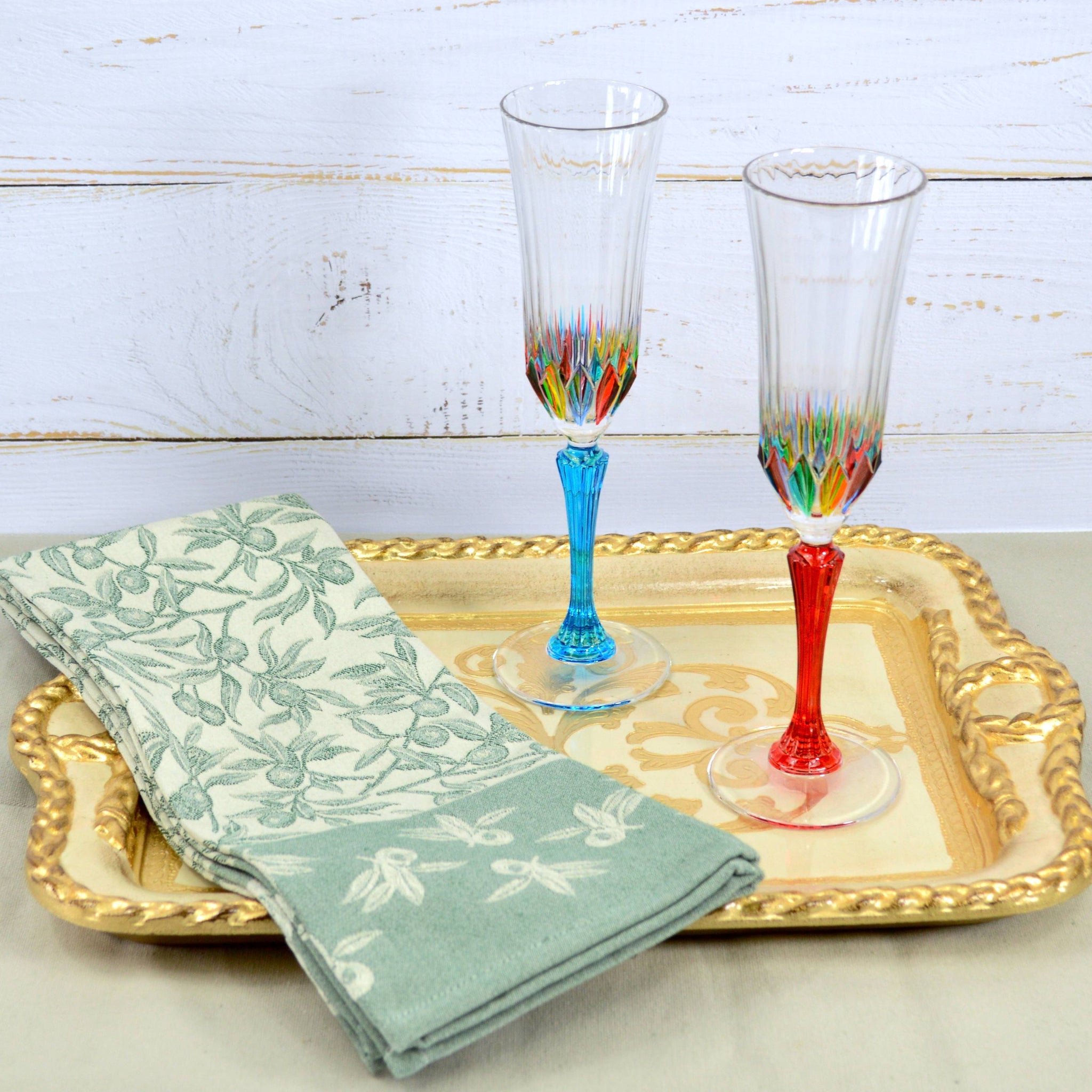 Busatti Oliva kitchen towel in assorted colors, made in Italy, displayed on a table with a natural fabric texture.