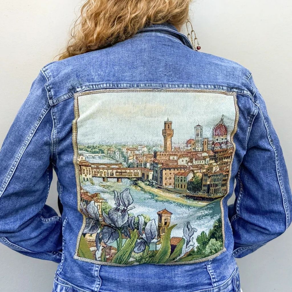 Denim jacket with Florence Italian art tapestry patch from My Italian Decor, featuring detailed floral and cityscape design.
