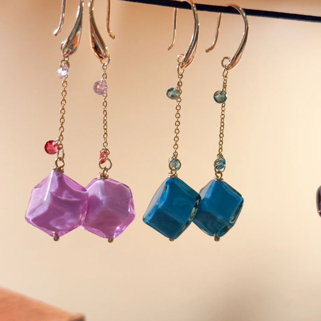 Hanging bead earrings from Dolce Collection featuring colorful Murano glass beads on silver chains.