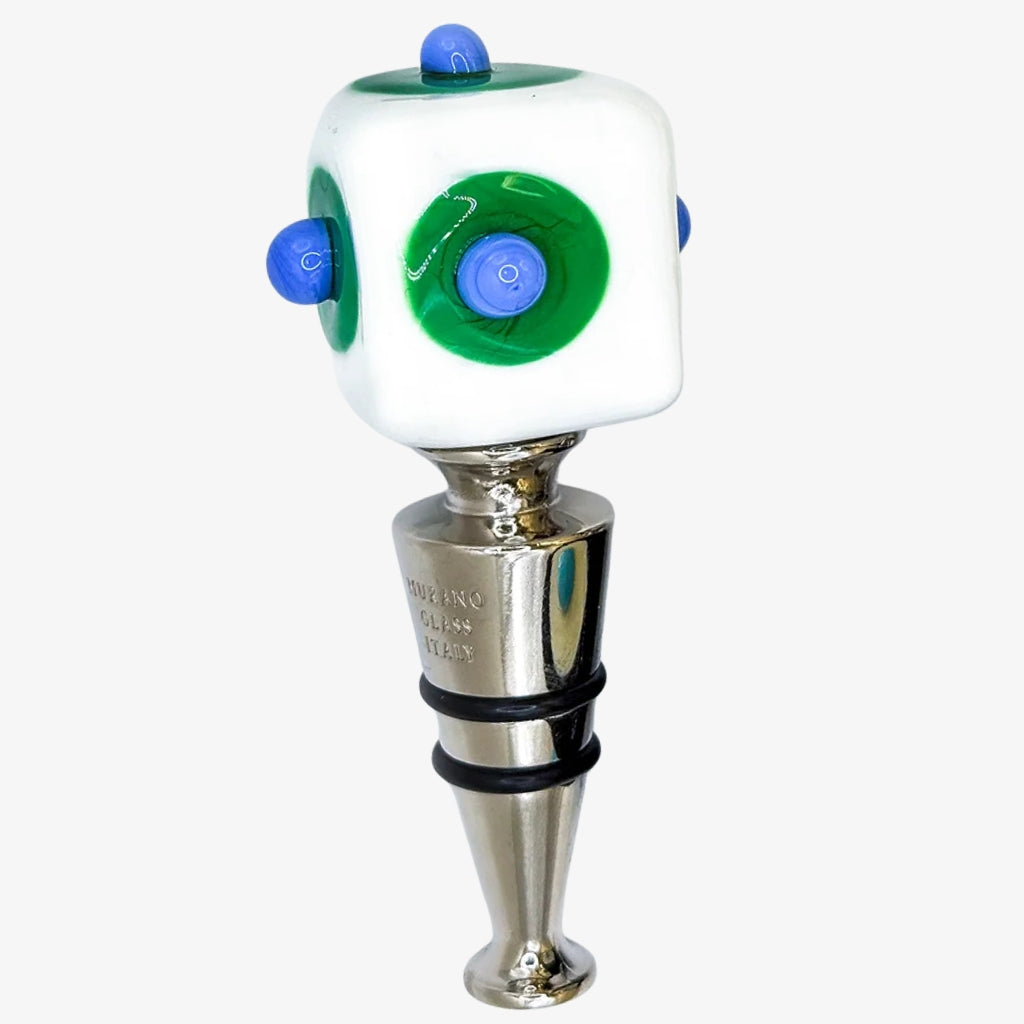 Two red glass wine bottle stoppers with silver metal bodies, one featuring a white circle with purple details and the other with green circles and purple dots, set against a plain white background.