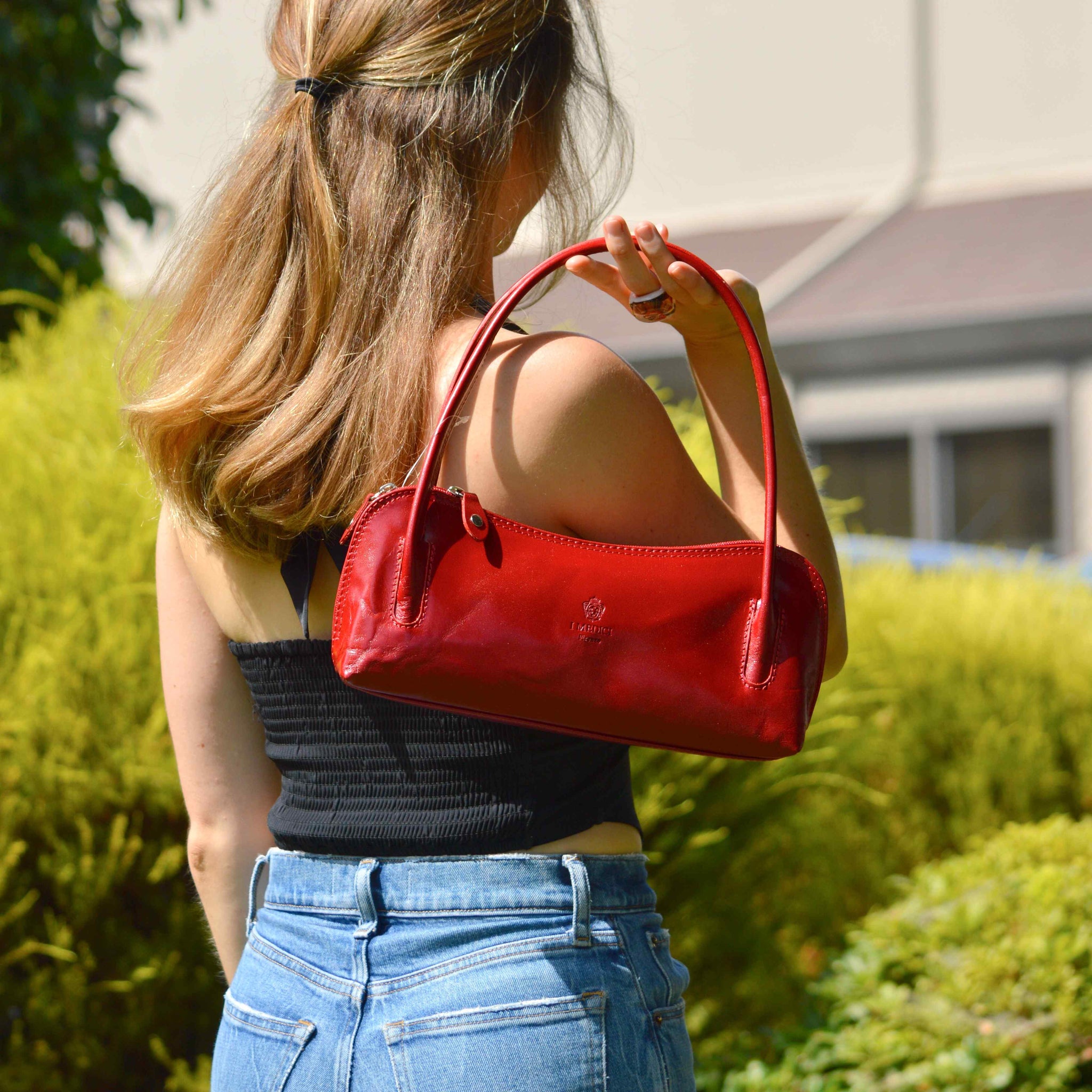 Red Carina shoulder bag by MyItalianDecor, made from Italian leather, shown on a model's back.