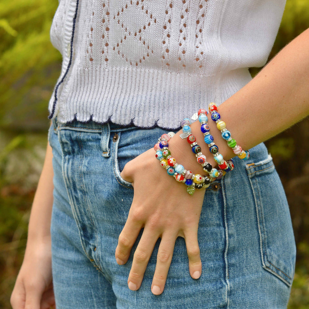 Handmade Italian Murano Millefiori beaded bracelet with 61 coin shaped glass top beads on a silver plated chain with a lobster clasp