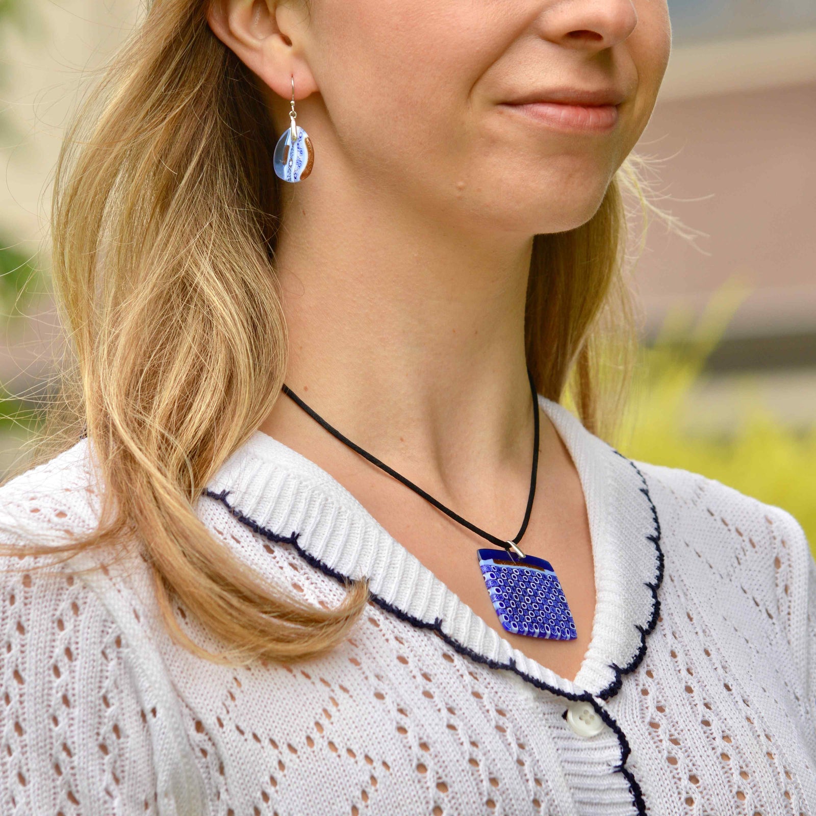 Cobalt Murano glass Millefiori mosaic square pendant with white accents, crafted in Italy, featuring intricate glass art on a pendant.