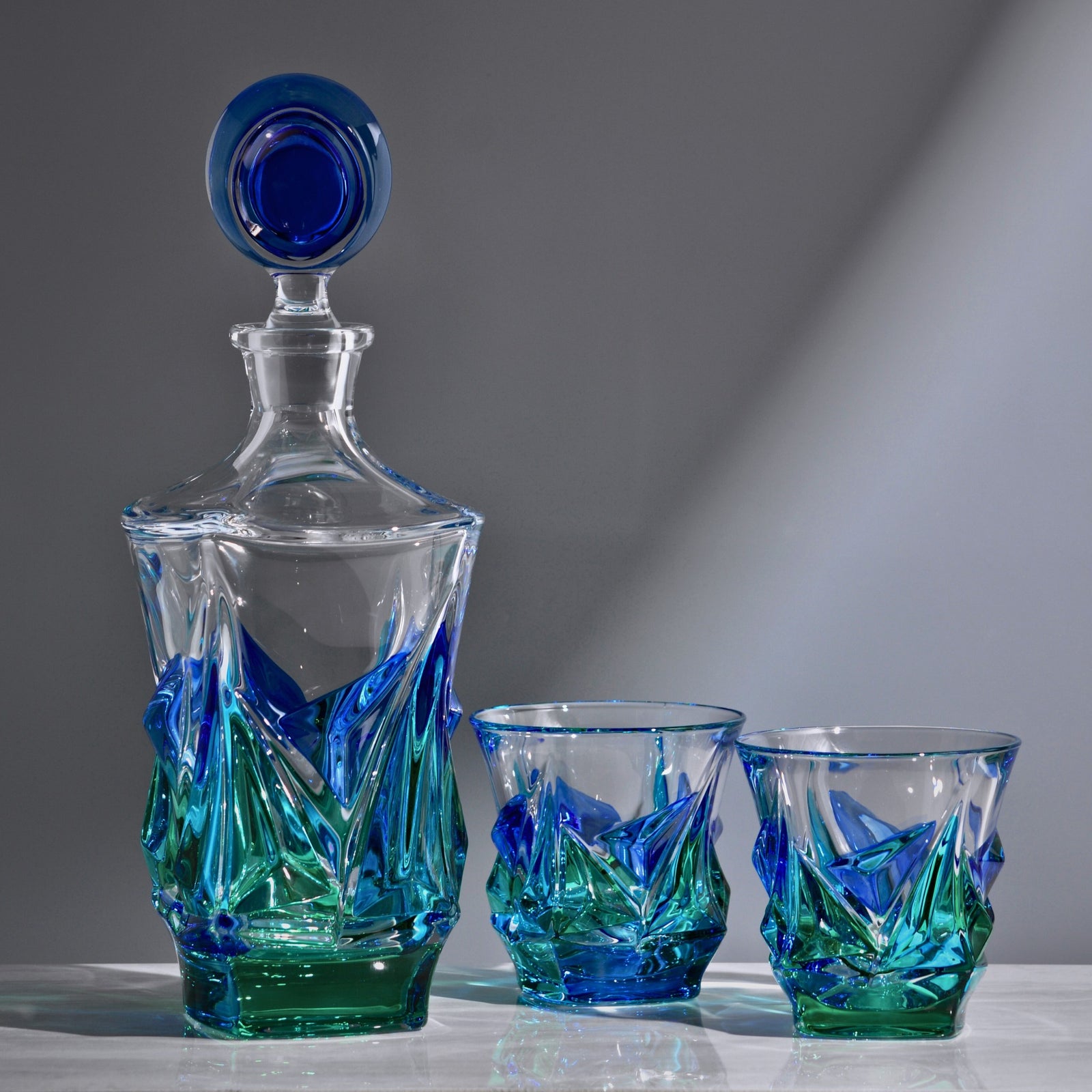 Hand-painted Italian crystal Empress decanter in blue and green by DZ, showcasing intricate craftsmanship and elegant design.
