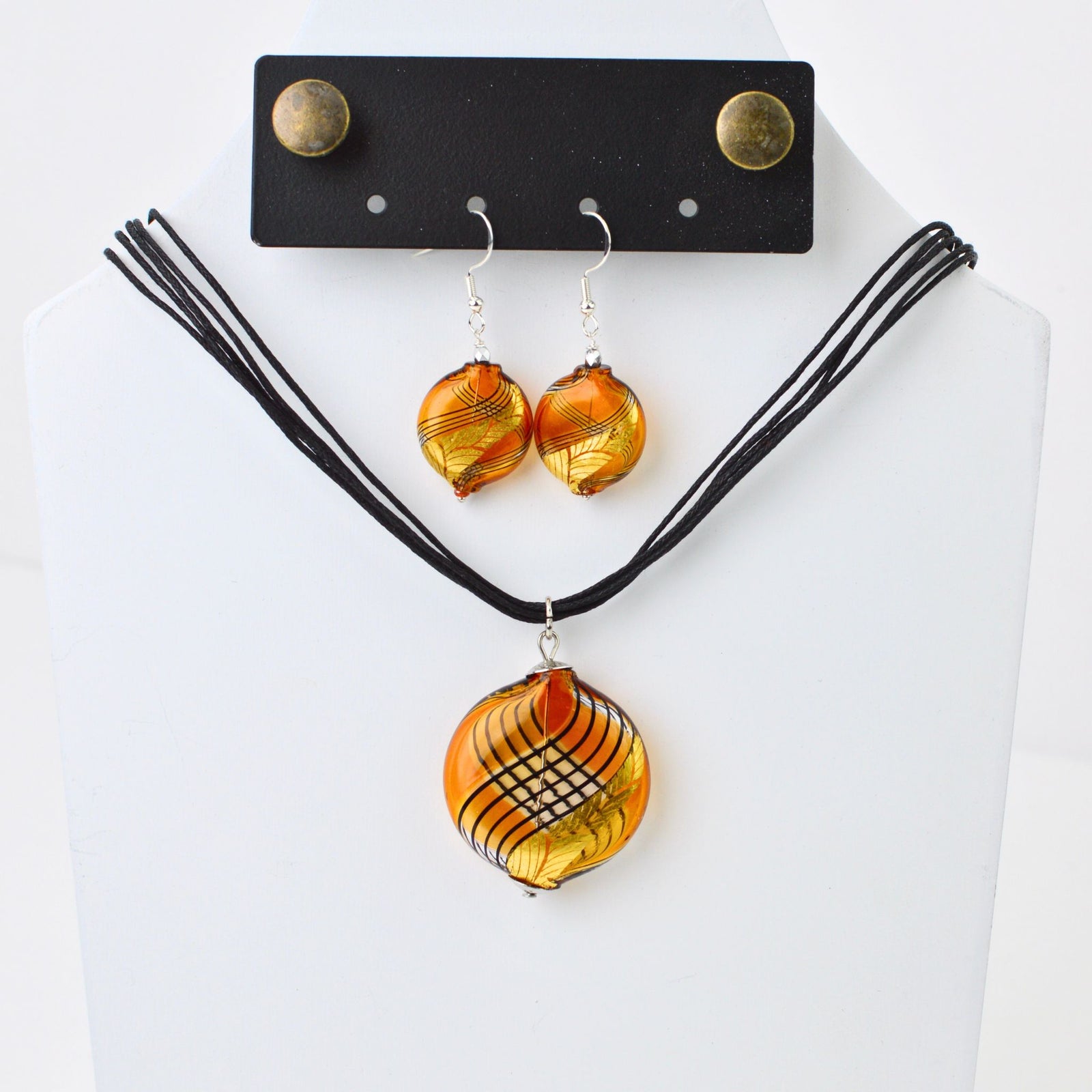 Handcrafted Murano Glass jewelry set with amber and gold necklace and earrings, featuring etched glass details.