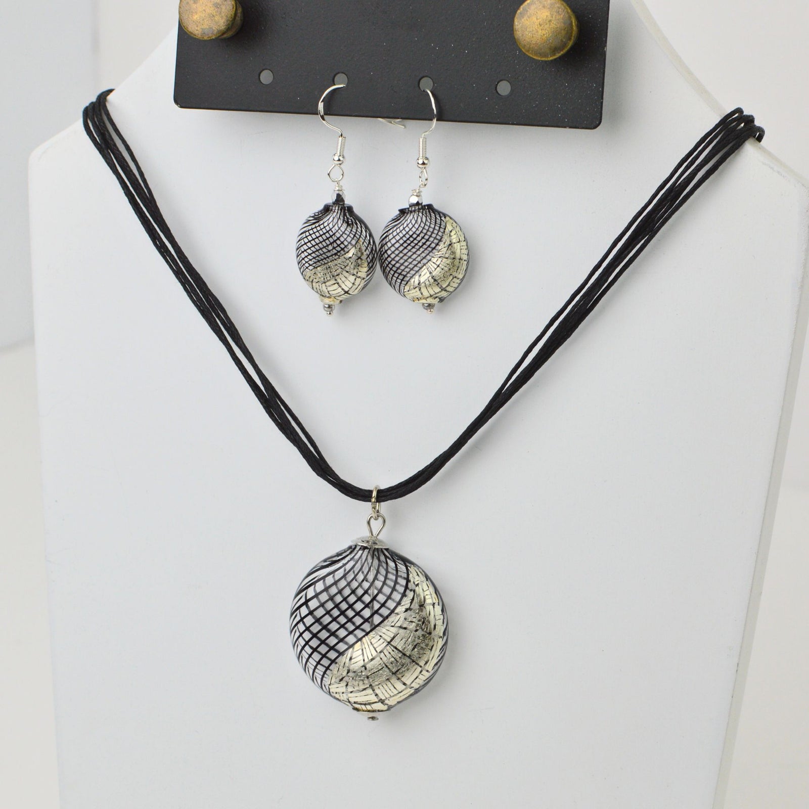 Handcrafted Murano Glass jewelry set with black and silver etched design, featuring a necklace and earrings from Italy.