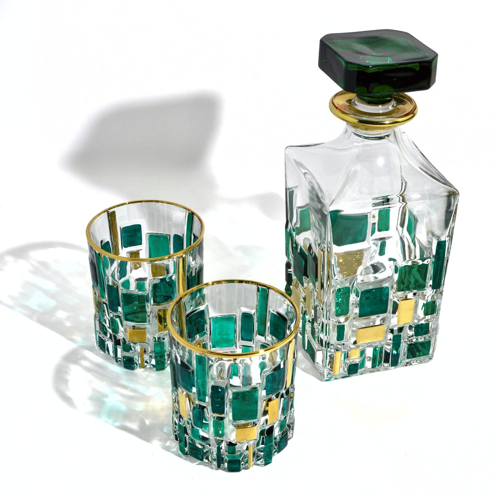 Elegant Etna hand-painted Italian crystal decanter with matching glasses in green and gold, showcasing intricate design and craftsmanship.