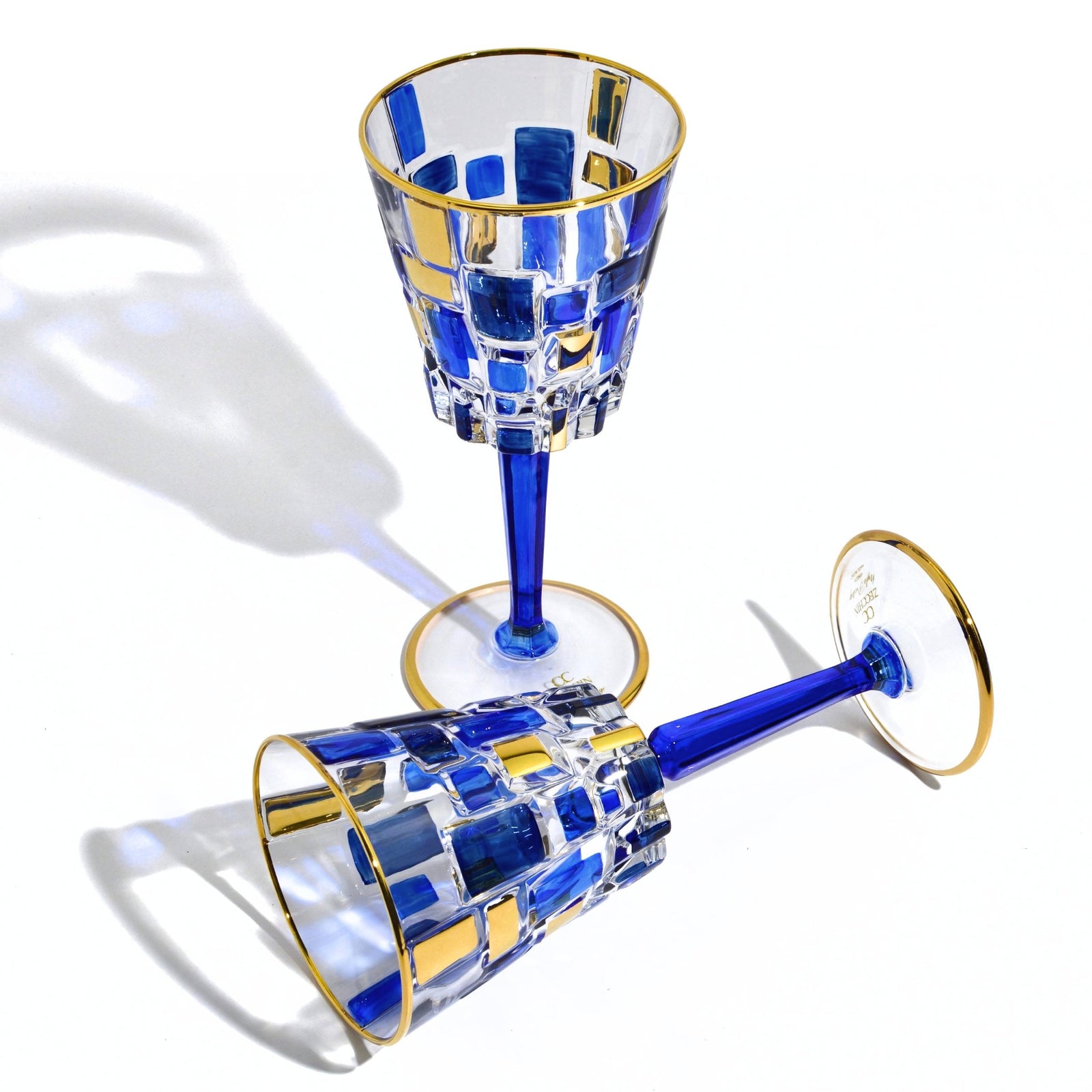 Elegant Etna Sapphire Blue and Gold Crystal Wine Glass by DZ, featuring a sleek design with vibrant blue and gold accents.