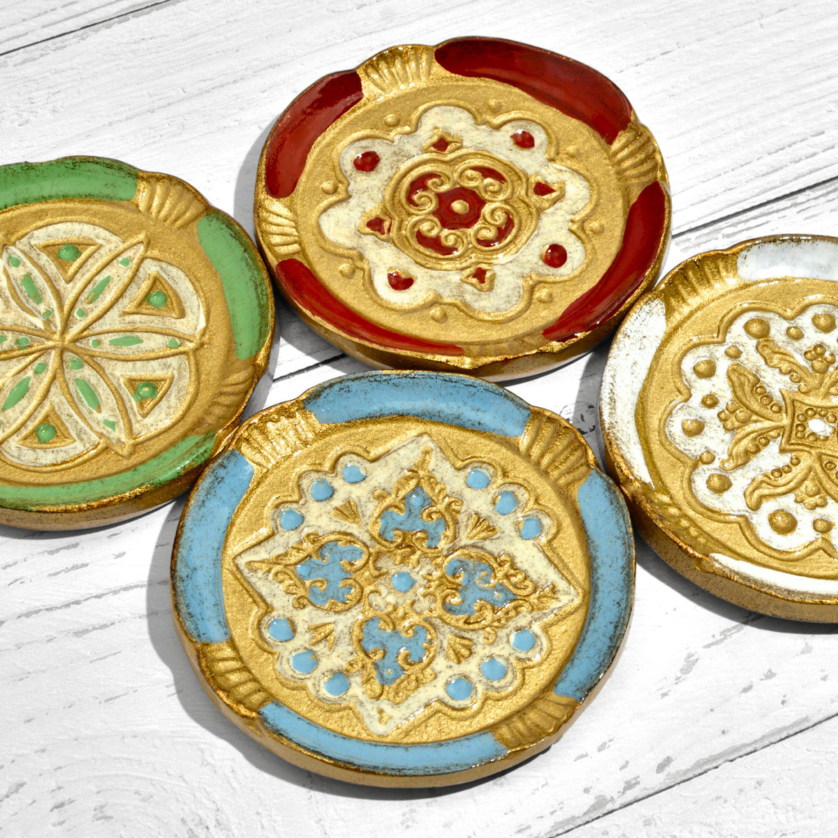 Set of Florentine wood coasters in various colors displayed on decorative trays by My Italian Decor.