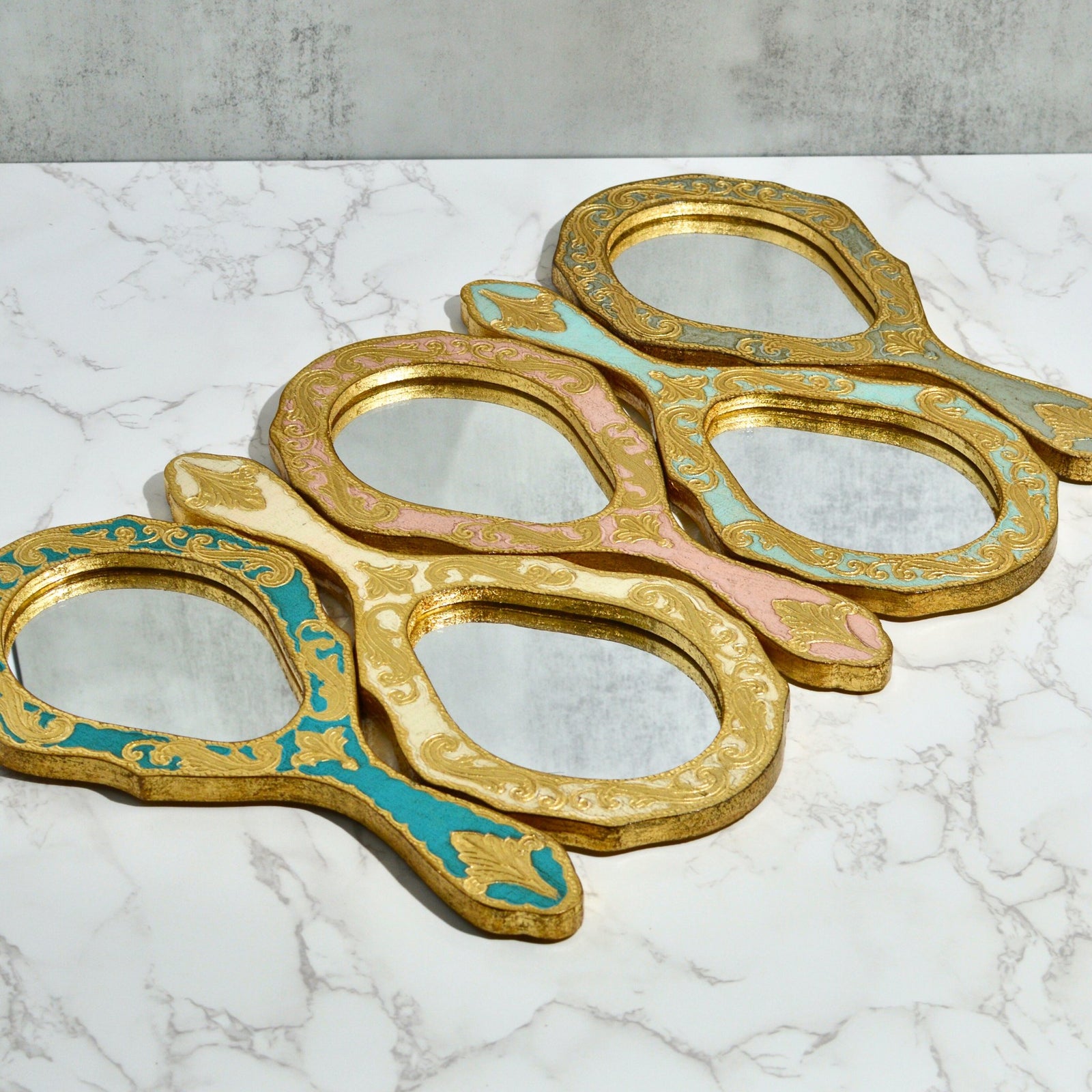 Florentine Wood Oval Hand Mirror by My Italian Decor with intricate wood design, made in Italy, featuring a polished oval mirror surface.