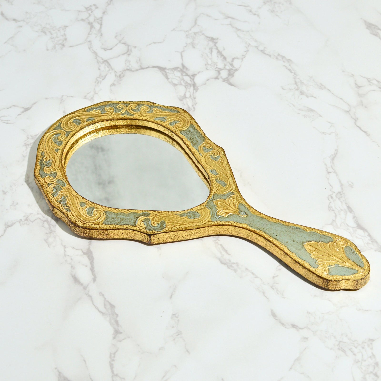 Florentine wood oval hand mirror with intricate design, made in Italy, by My Italian Decor, featuring a polished wooden frame.