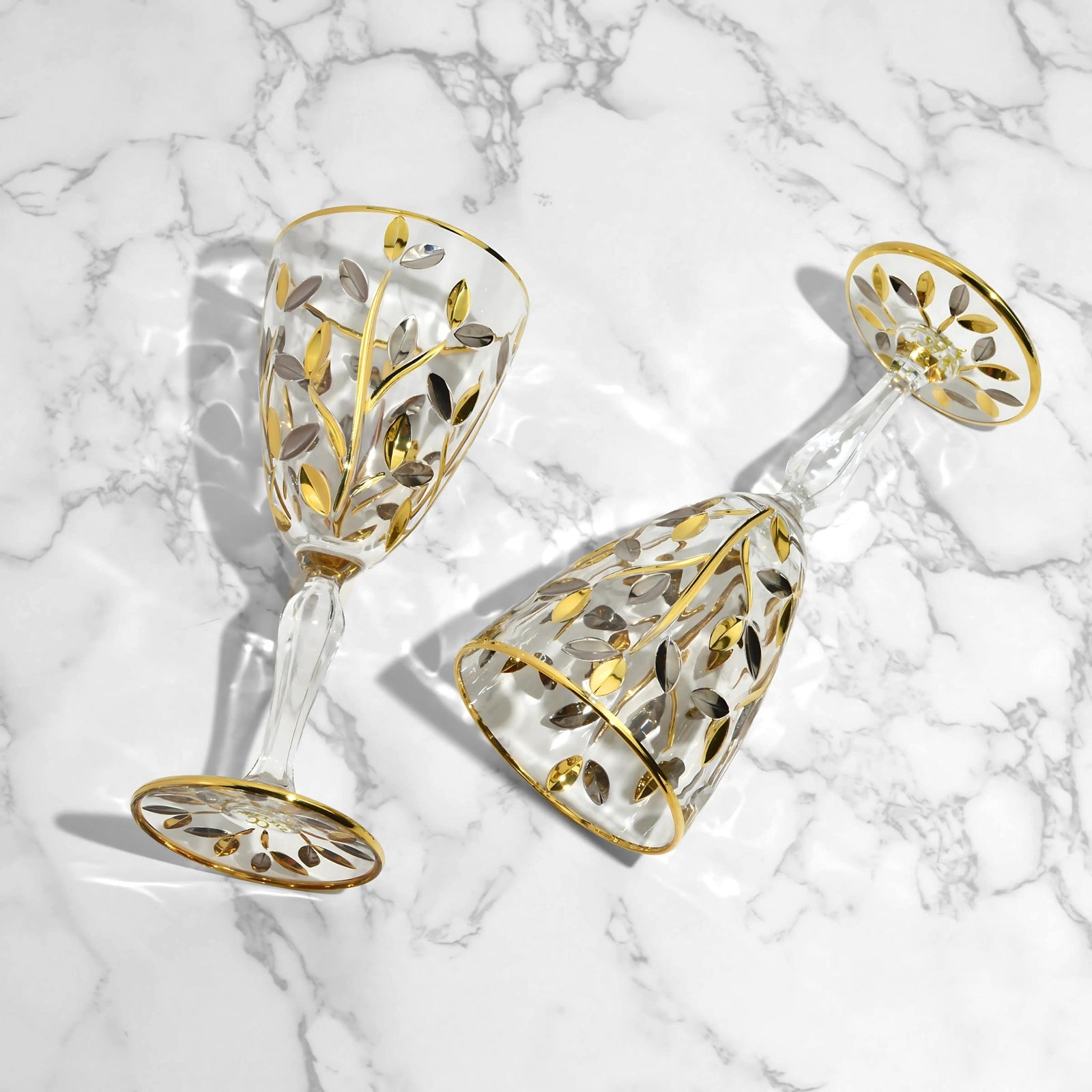 Set of two DZ Flowervine wine glasses with platinum and gold accents, featuring elegant, clear glass bowls and slender stems.