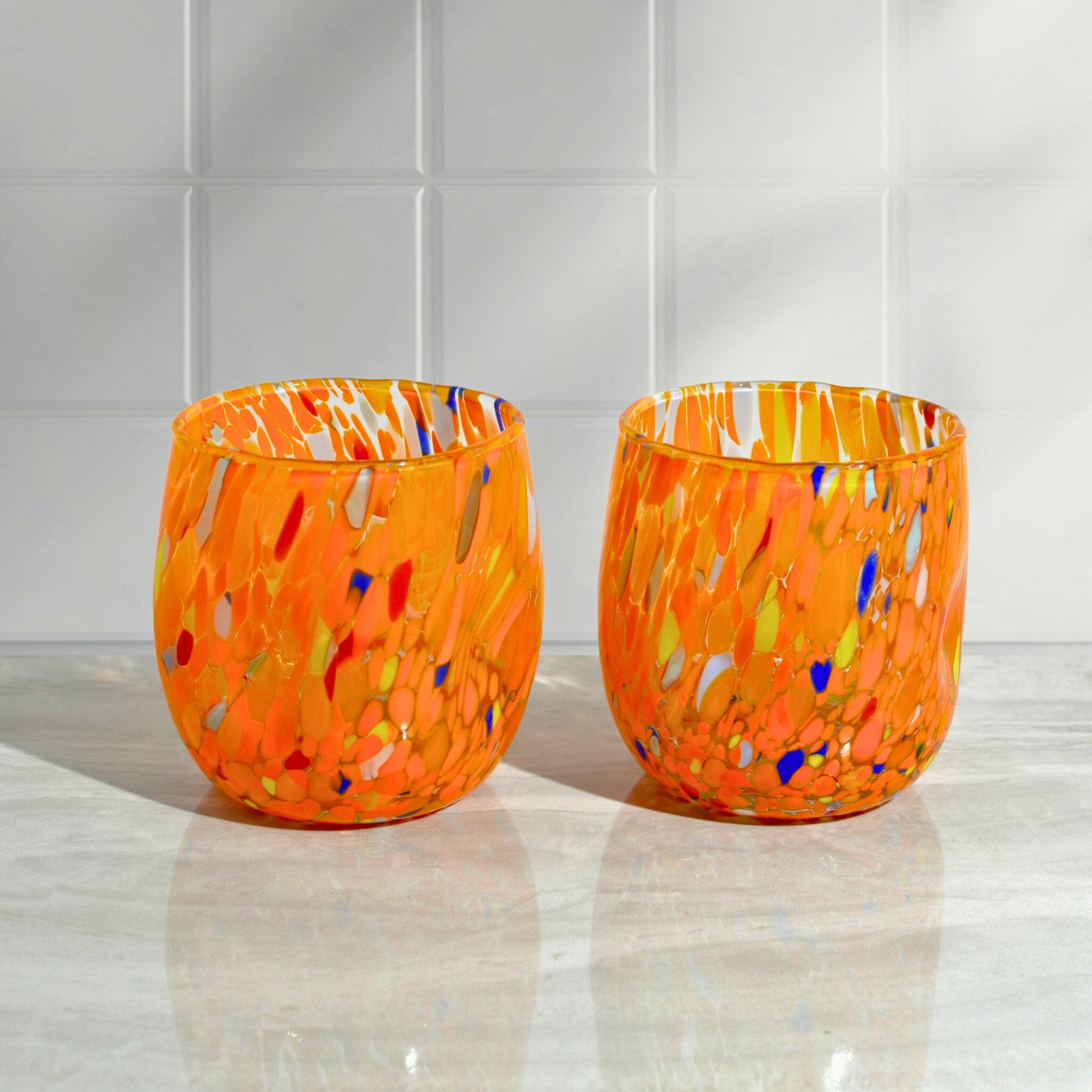Two orange Murano glass tumblers from the Fresca set by My Italian Decor, round shape and handcrafted in Italy.