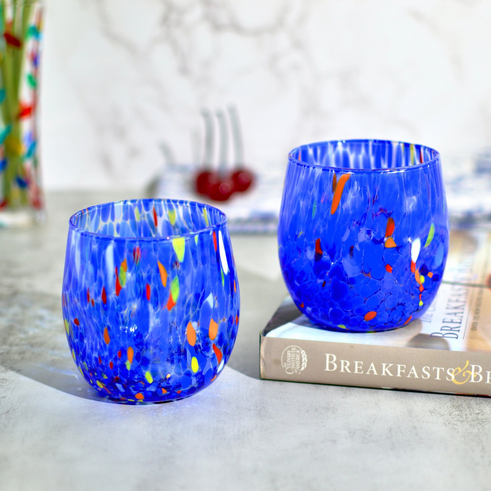 Two cobalt blue Murano glass round tumblers from the Fresca set by My Italian Decor, made in Italy, with a smooth, glossy finish.