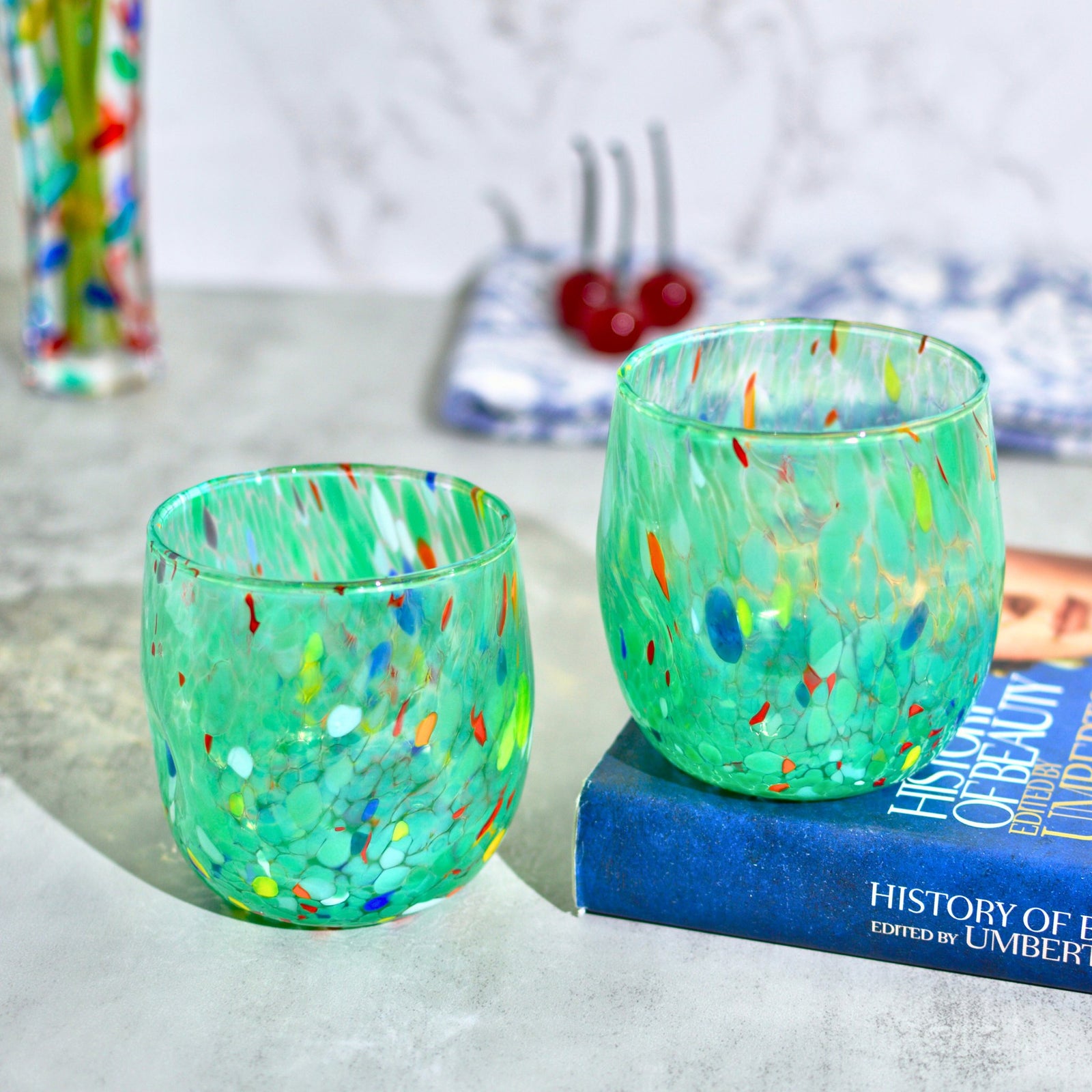 Set of two Murano glass round tumblers in vibrant colors from Italy, featuring elegant craftsmanship and clear design.