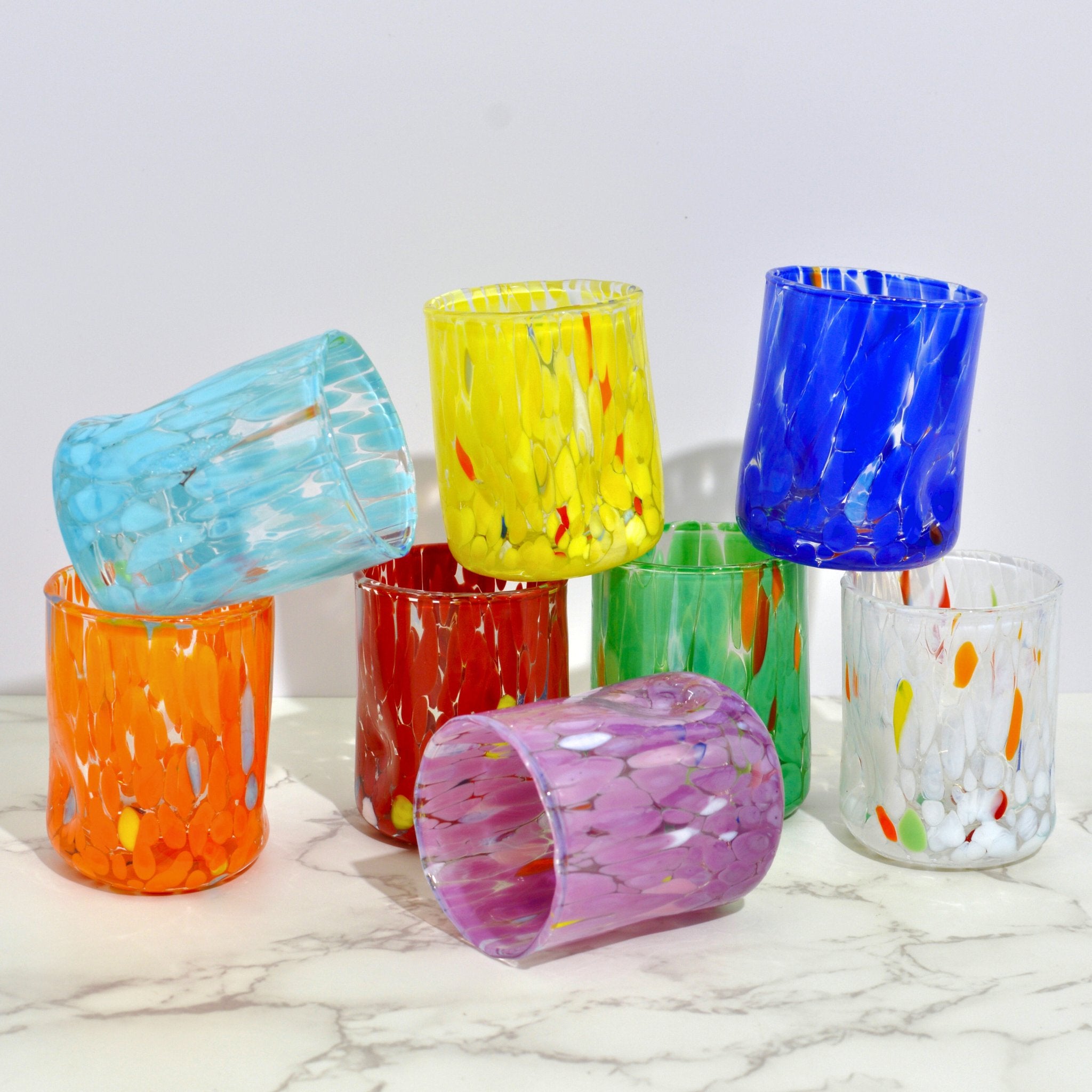 Set of two Murano Glass Fresca shot glasses by MyItalianDecor stacked, featuring colorful, handcrafted Italian glassware.