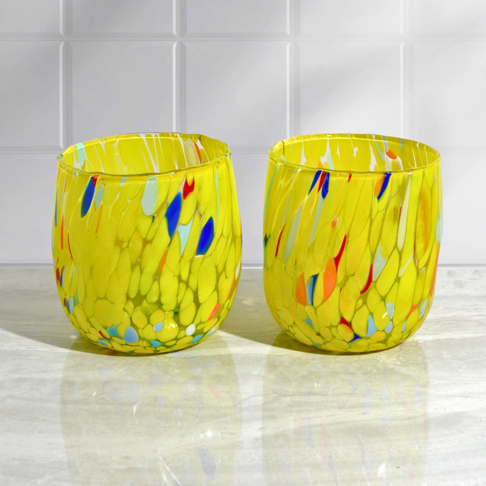 Set of two Murano glass round tumblers in vibrant colors from Italy, featuring elegant craftsmanship and clear design.