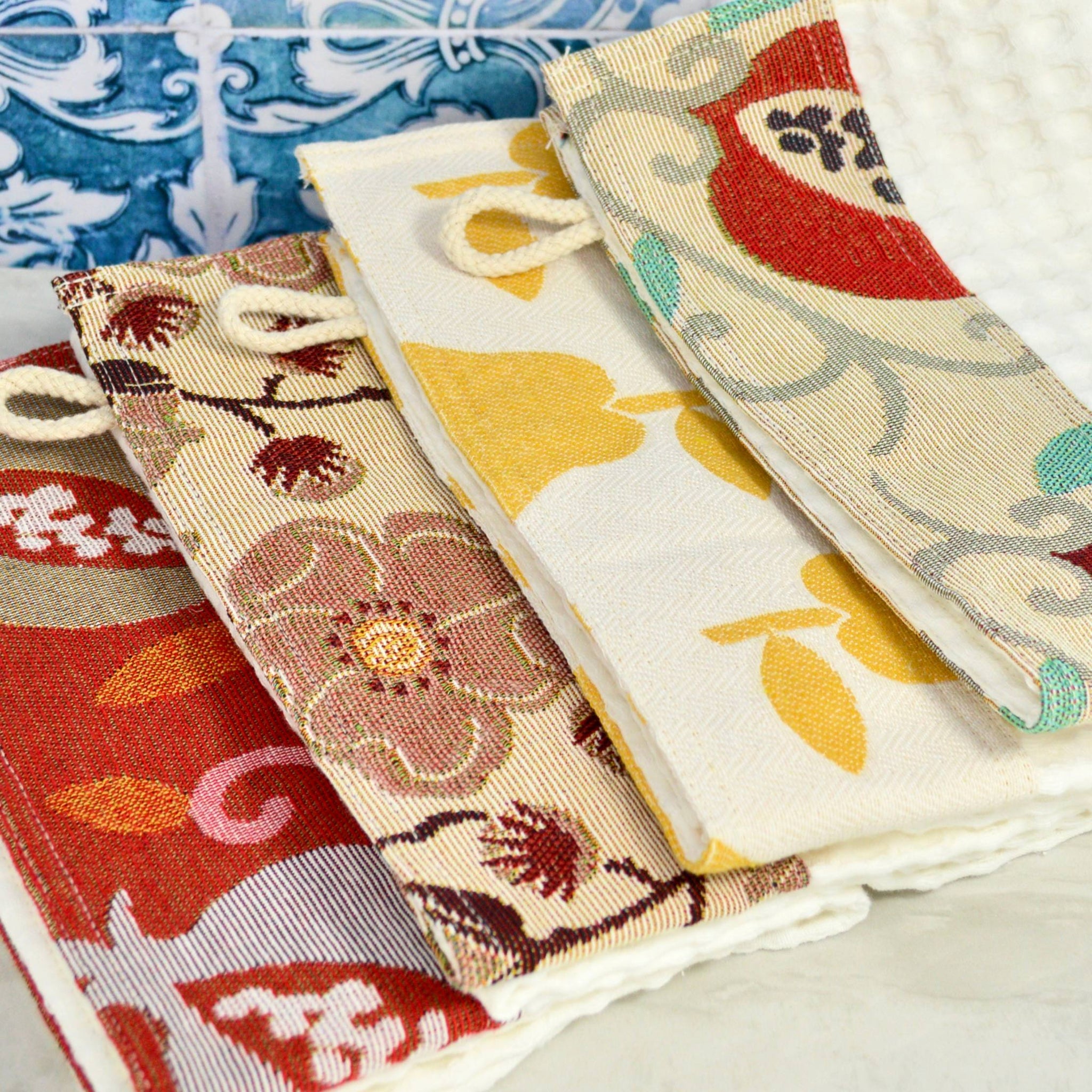 Assorted color kitchen towels by My Italian Decor, made in Italy, featuring vibrant woven designs for table and kitchen use.