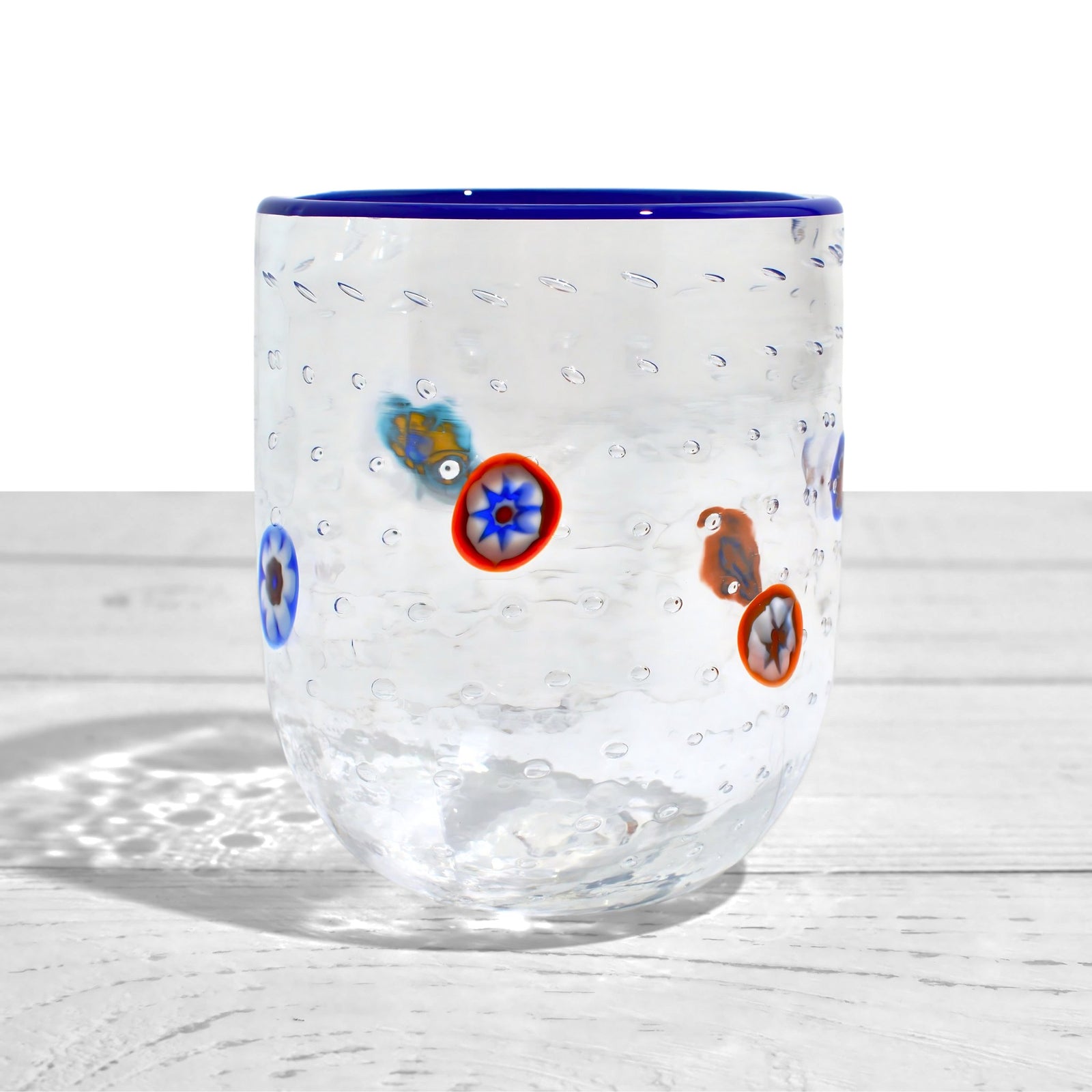Set of four Gioia Clear Millefiori Murano tumblers with colorful rims, made in Italy, showcasing vibrant hand-blown glass design.