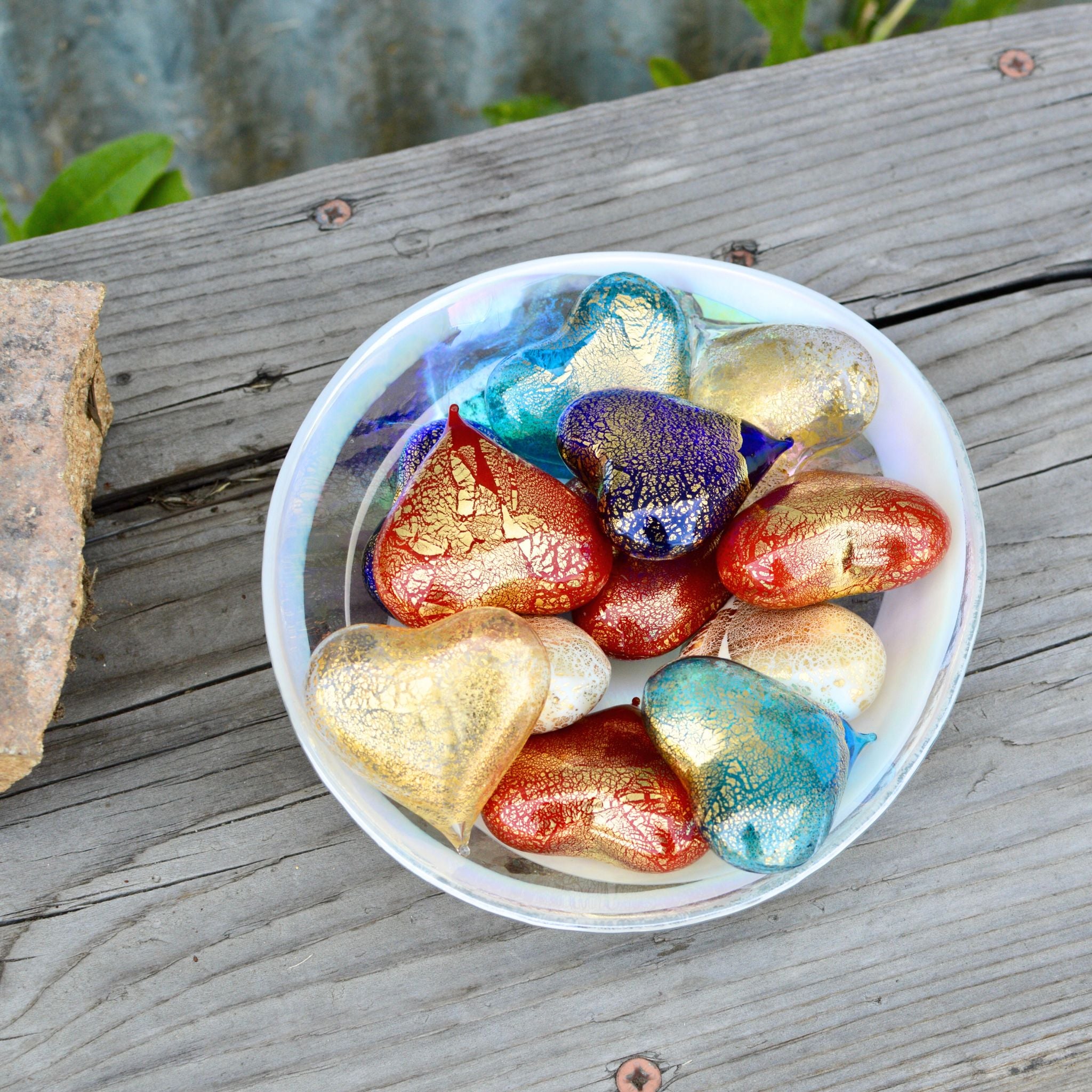 Set of three small Murano glass heart figurines in red, white, and blue in a bowl, crafted in Italy by MyItalianDecor.