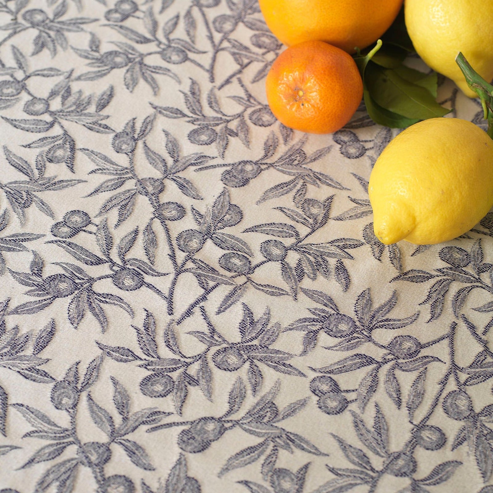 Green Busatti Oliva table runner made in Italy, showcasing intricate linen design for elegant table decor.