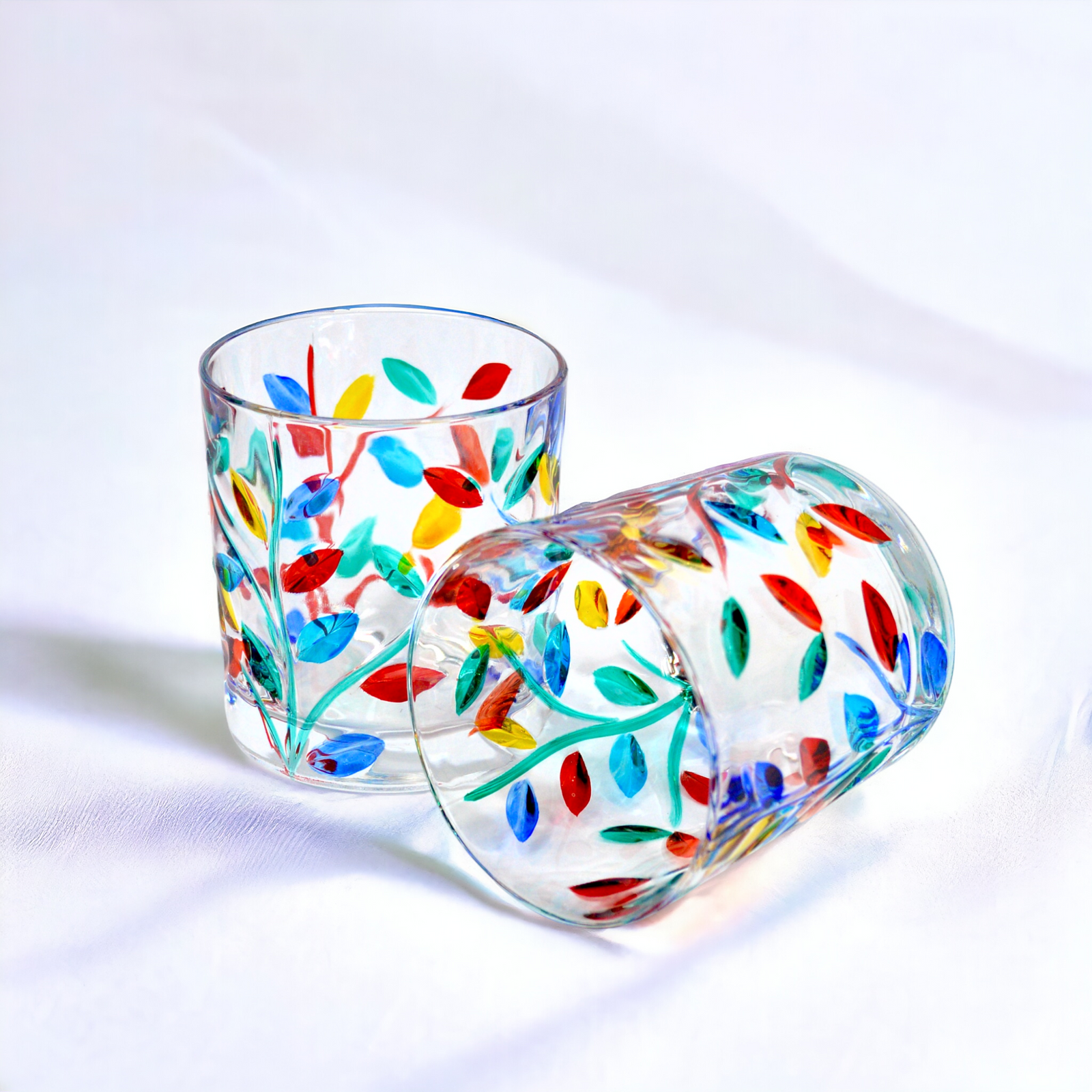 Set of two DZ Flowervine short drink tumblers made of hand-painted Italian crystal with floral design, front and back views.