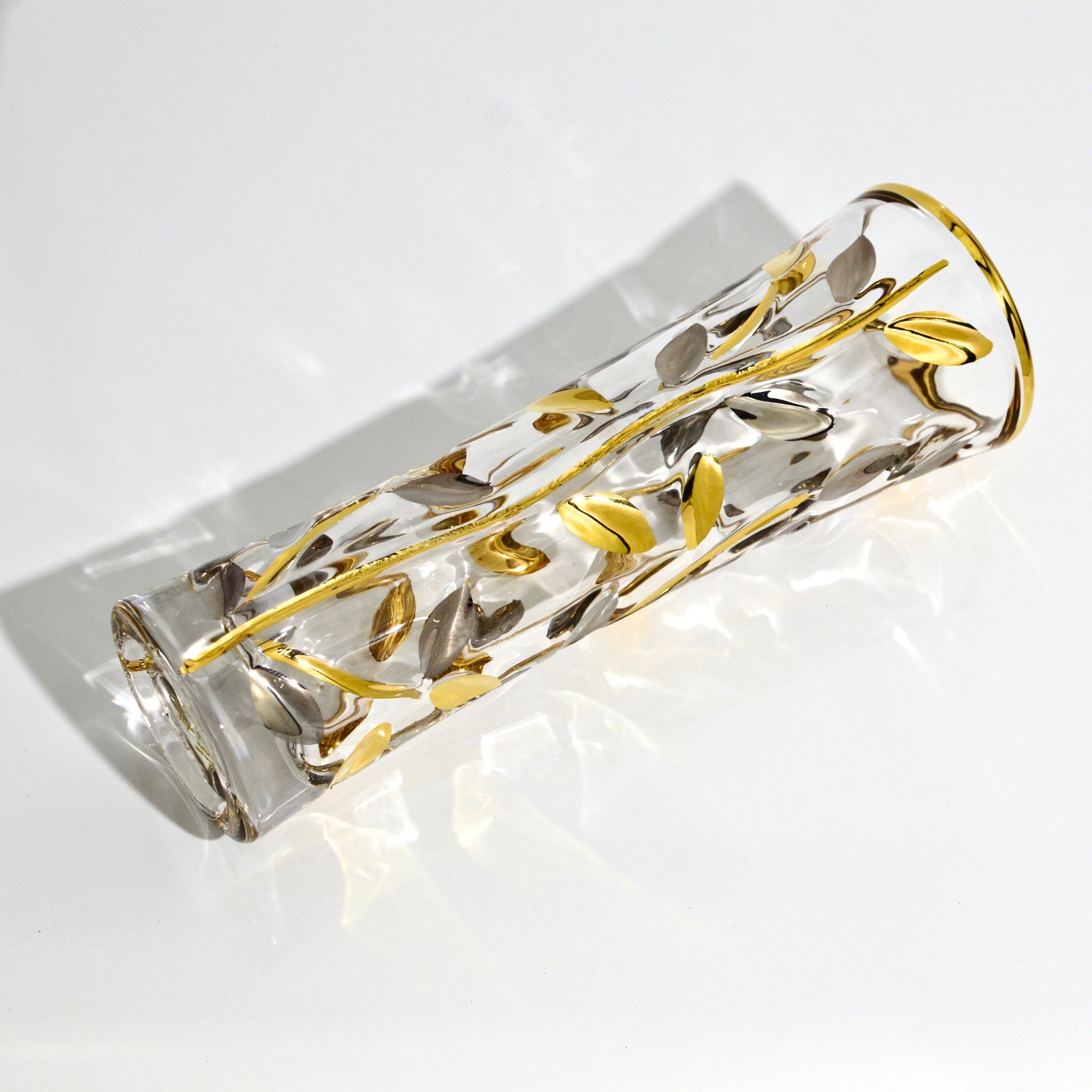 Flowervine platinum and gold Italian crystal bud vase from MyItalianDecor lying on a surface, showcasing elegant craftsmanship and design.