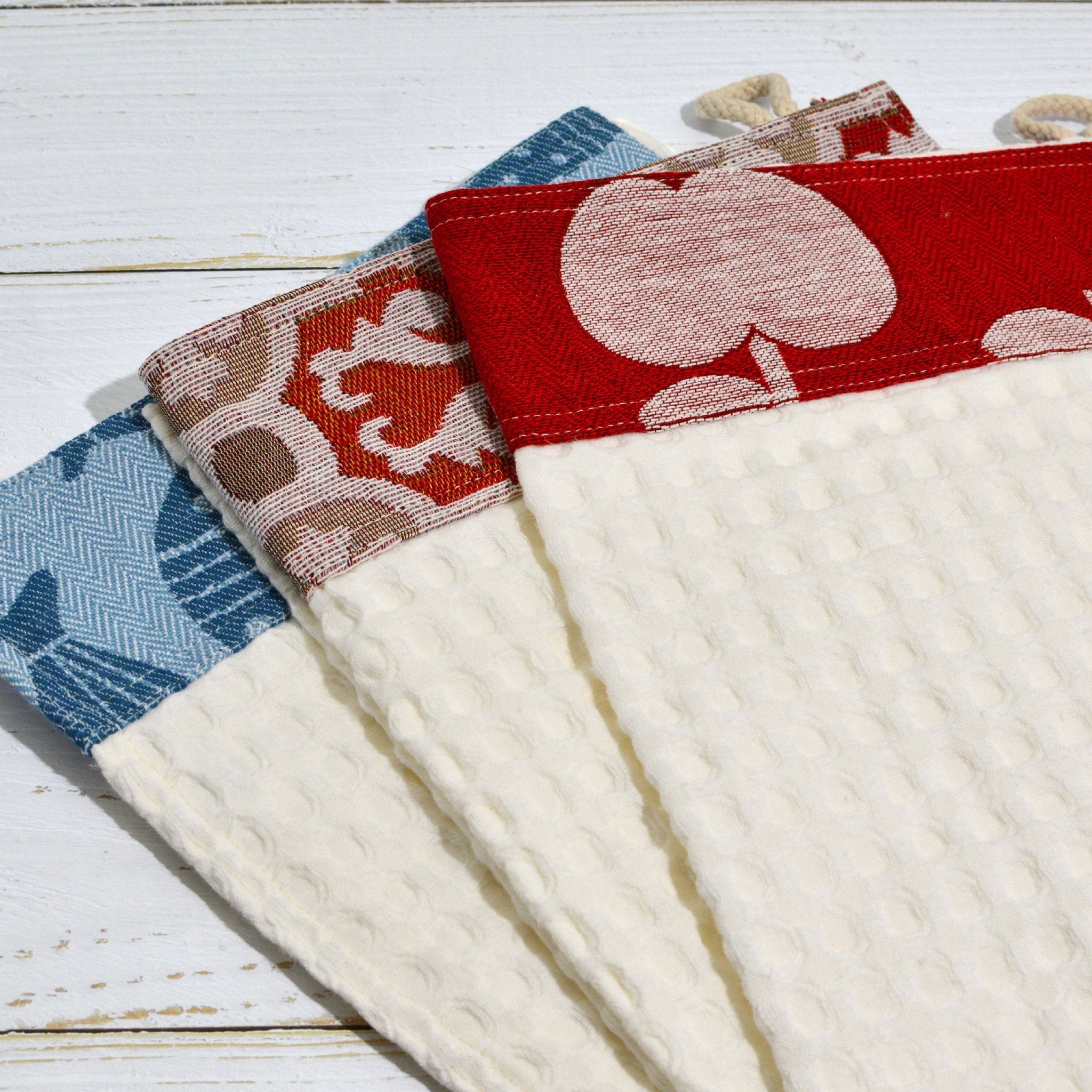 Set of three colorful Italian-made kitchen towels with assorted patterns, perfect for table linens and kitchen decor.